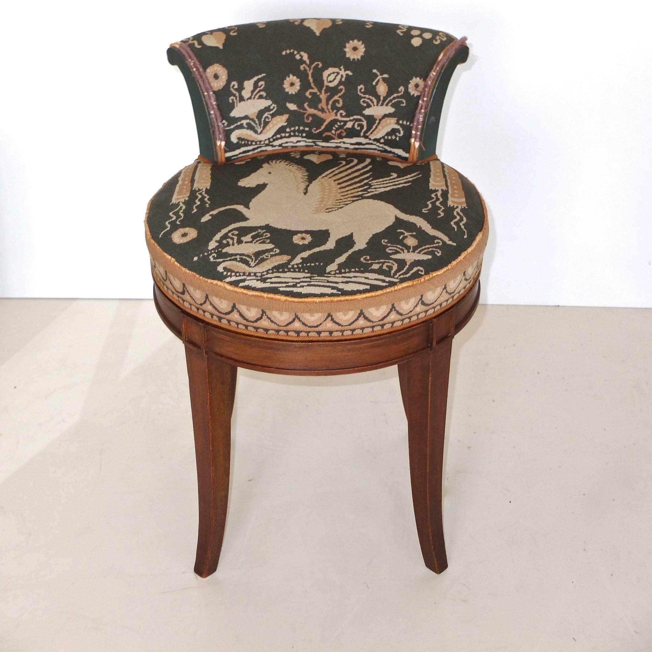 Lovely vintage swivel piano or vanity stool in the style of Edward Wormley for Dunbar and Samuel Marx, in walnut with slightly flared tapered legs and short backrest,

Pillbox cushion and backrest covered in handcrafted needlepoint with stylized