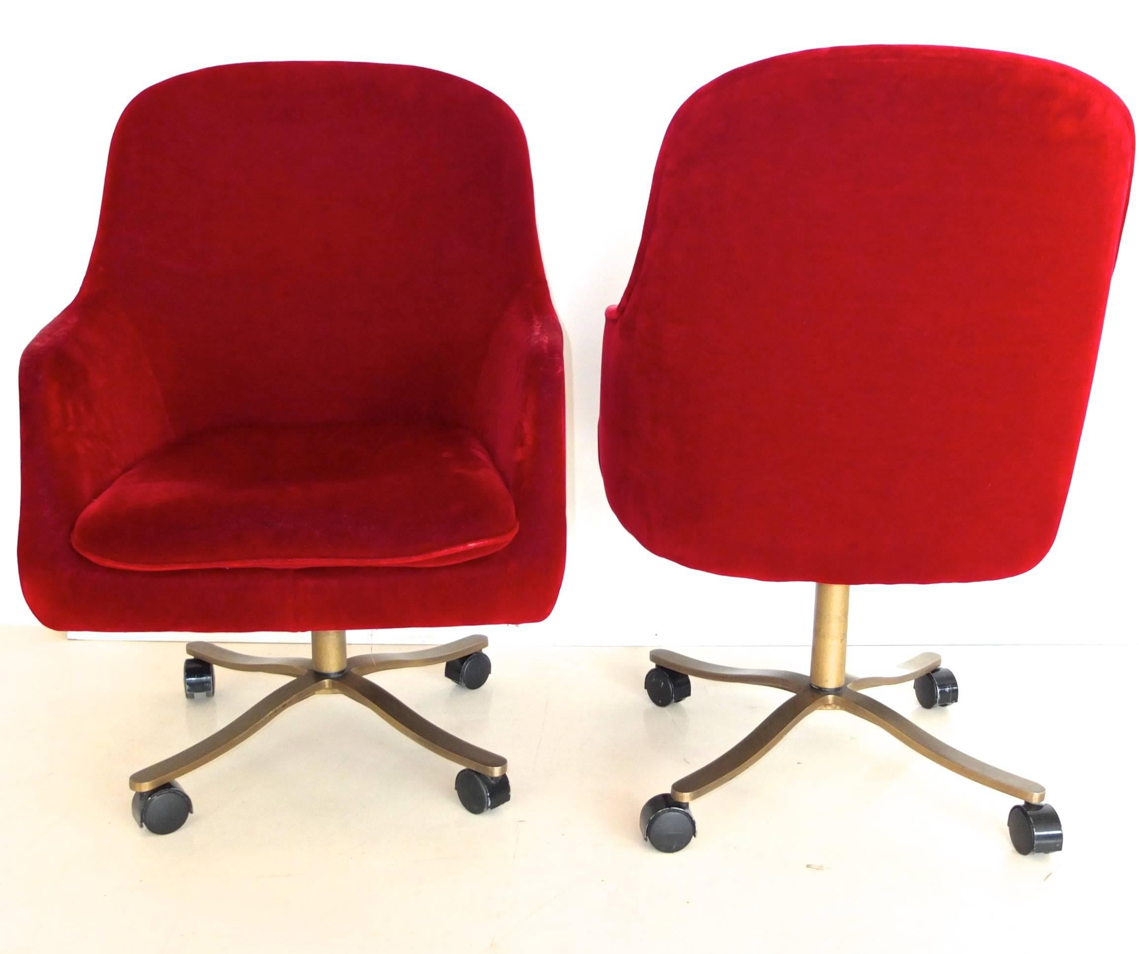 We have two of these vintage Nicos Zographos high quality executive swivel or return chairs, available individually or as a pair.

Each chair has a solid bronze four star base on wheels and is upholstered in claret red mohair.

They both have