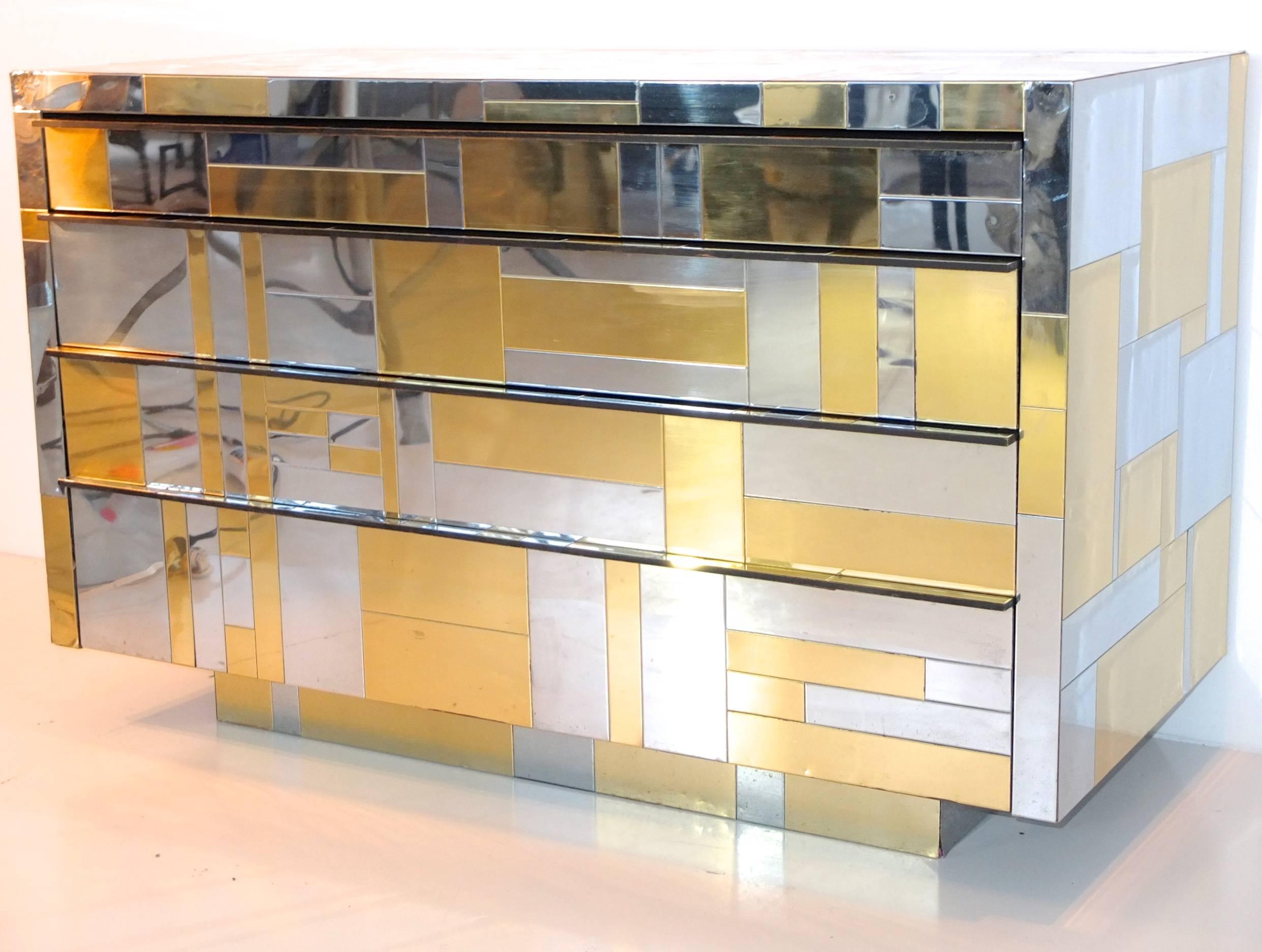 A cabinet of four drawers by Paul Evans from the Directional Cityscape Collection, USA, 1970.

Brutalist Bling: Chrome, brass and stainless-steel tile clad rectangular cabinet case on recessed plinth base with four sliding drawers lined with black