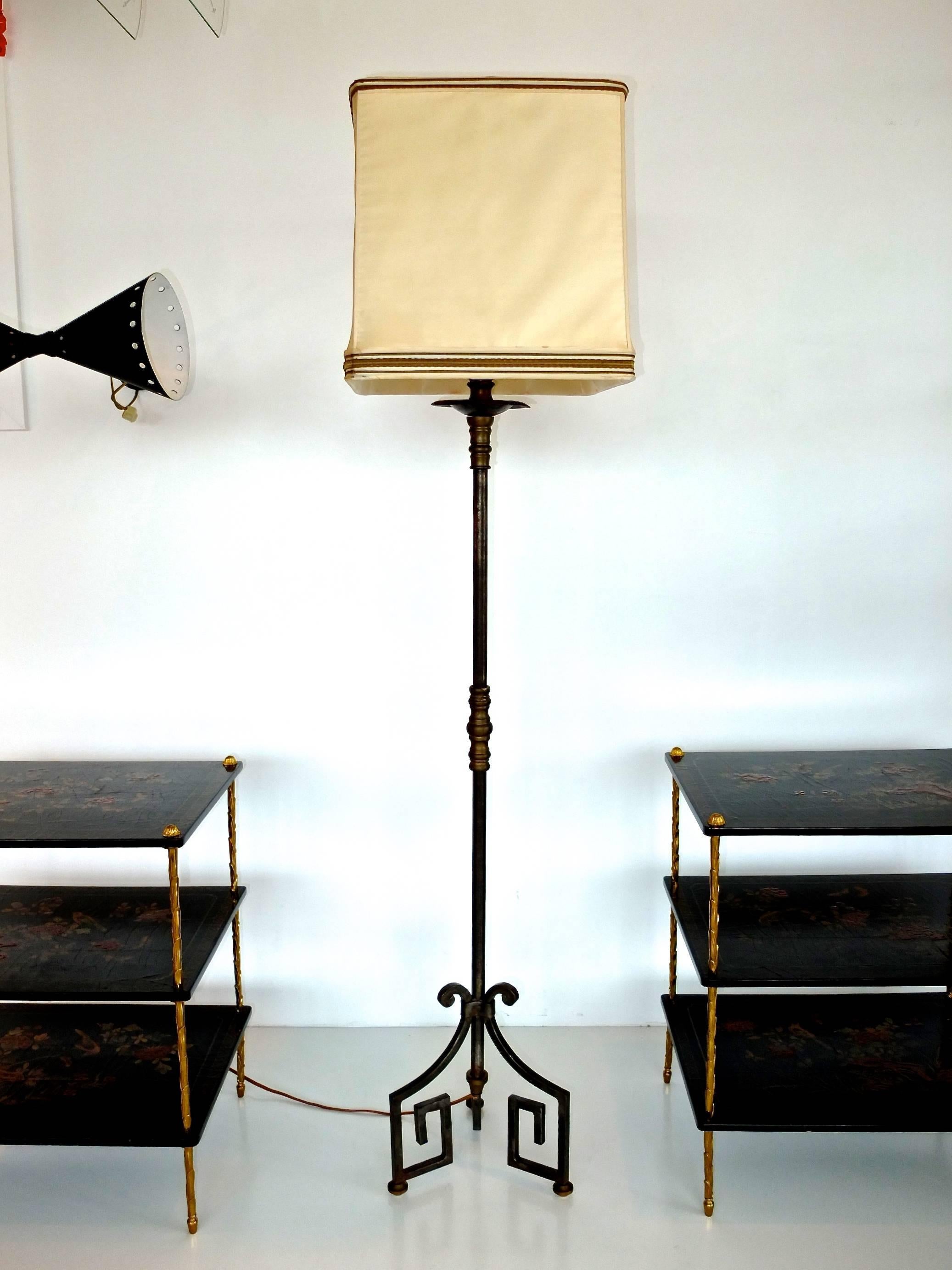 High end French Mid-Century floor lamp in fer forge hand-wrought iron with Greek Key tripod base and bronze embellishments....bronze foot pads and bronze turning midway on stem.

Original box frame shade included. 15