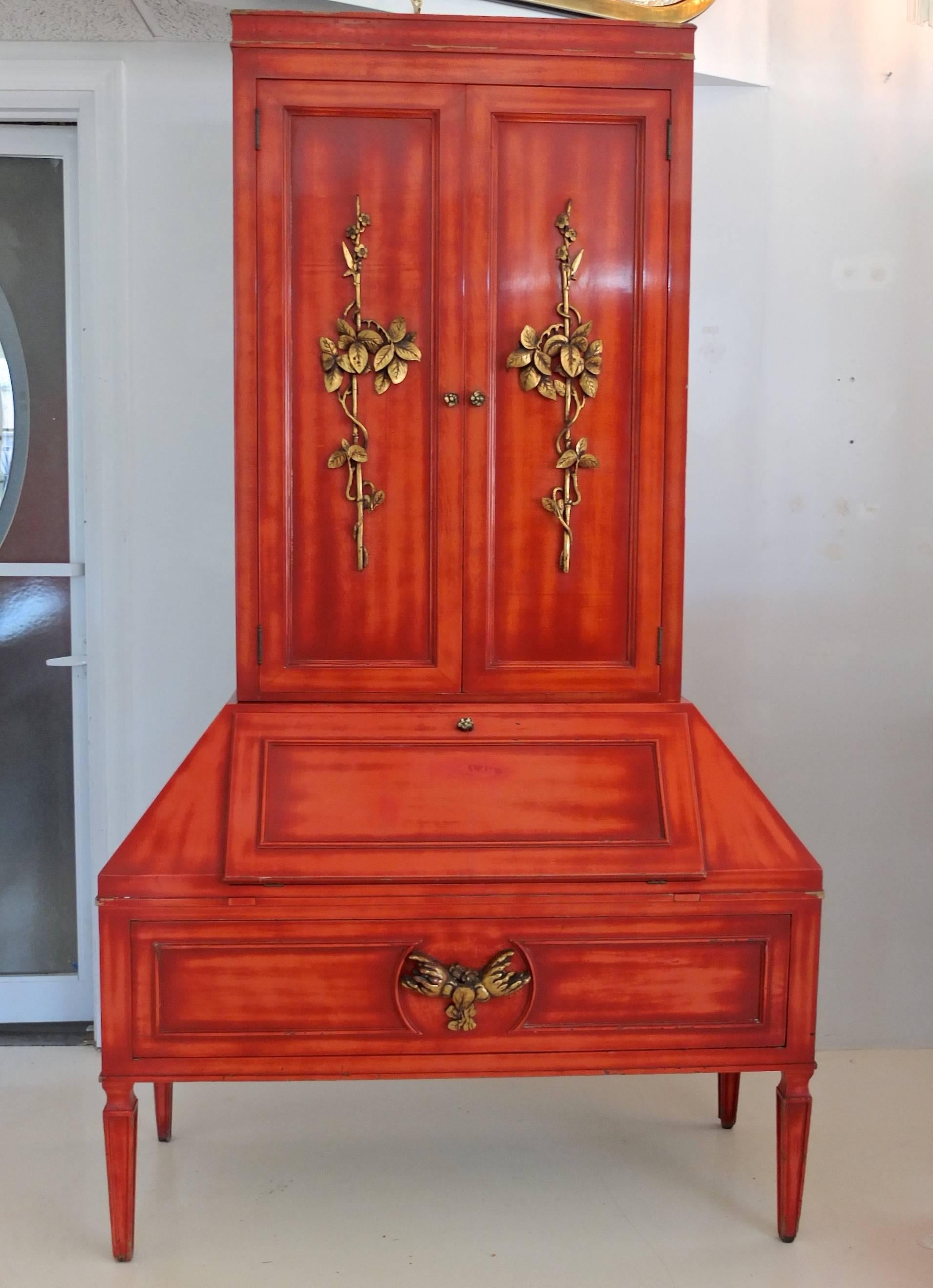 Extremely rare, possibly one of a kind, secretary cabinet with bookcase by the godfather of exotic modernism, James Mont, circa 1950. Hand rubbed cinnabar lacquered finish with applied hand-carved giltwood embellishments. Mont's lacquer finishes are