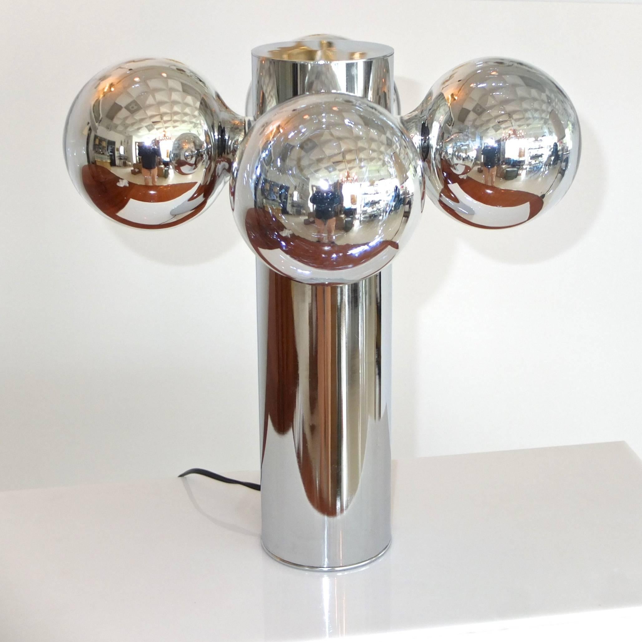 Extraordinary space age table lamp from the late 1960s early 1970s. Chrome plated steel cylinder 4 inches diameter with four standard Edison screw cap sockets below the top. Includes the four original custom 5 inch diameter glass globe bulbs which