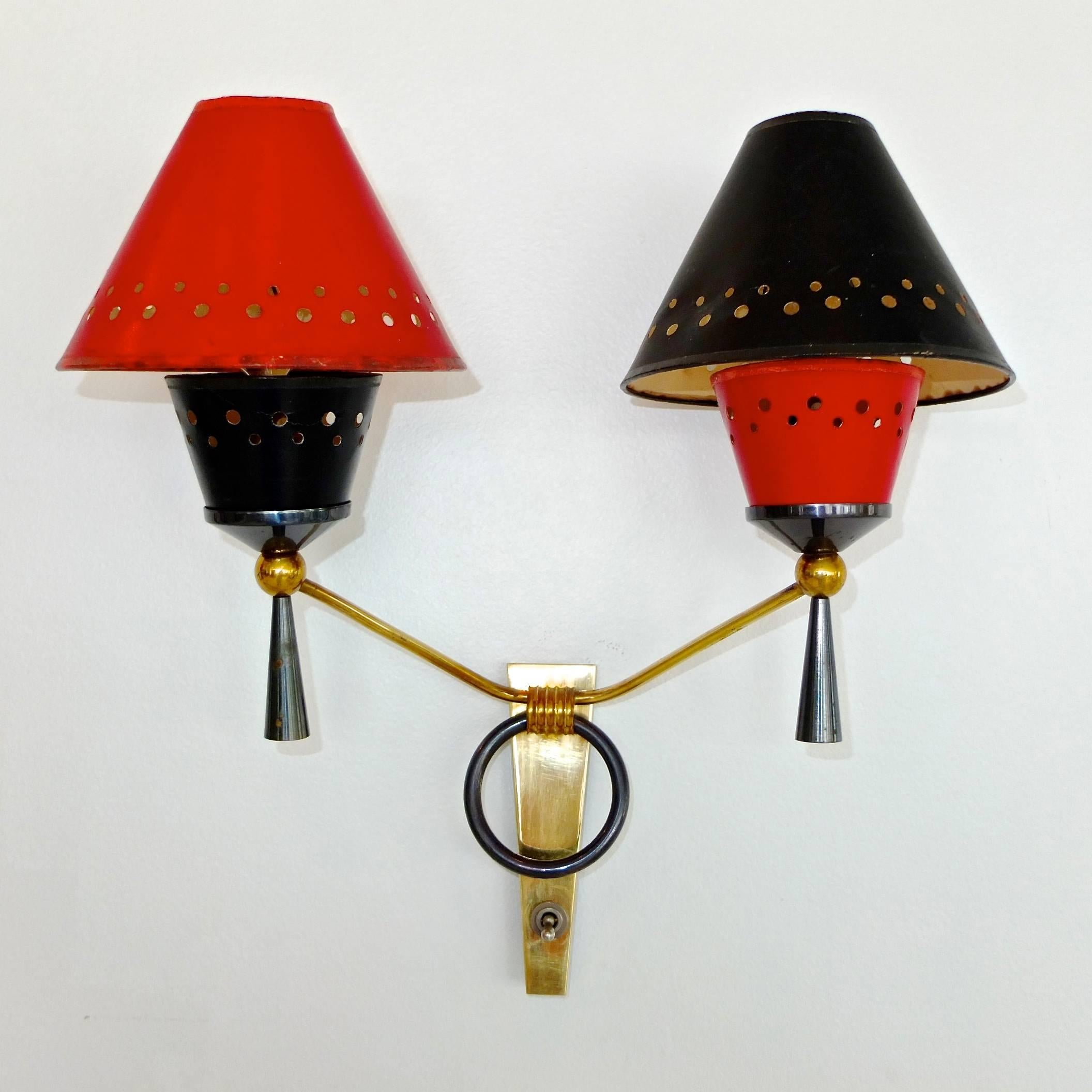 We actually have two pair available but this listing is for one pair of 1950s, French wall lamps by Maison Lunel in the style of Jacques Adnet having double brass arms with gunmetal accents. The wedge form backplate has a flick on/off switch.