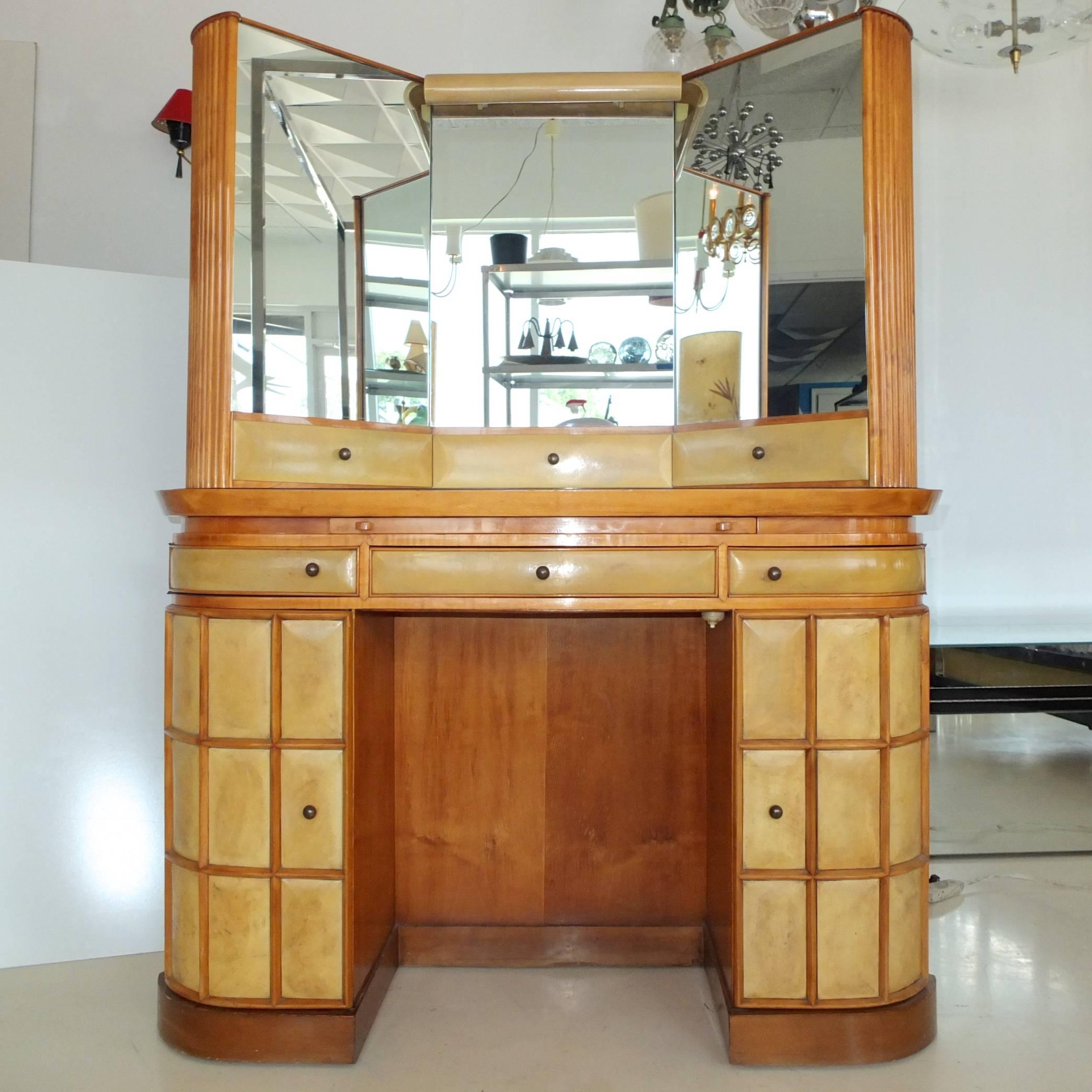 Custom Italian vanity, dressing table or secretary with triptych mirror, in parchment and fruitwood, possibly pear wood, attributed to Paolo Buffa. Italy, circa 1935.

The table and mirror are one unit and are not intended to detach. The entire