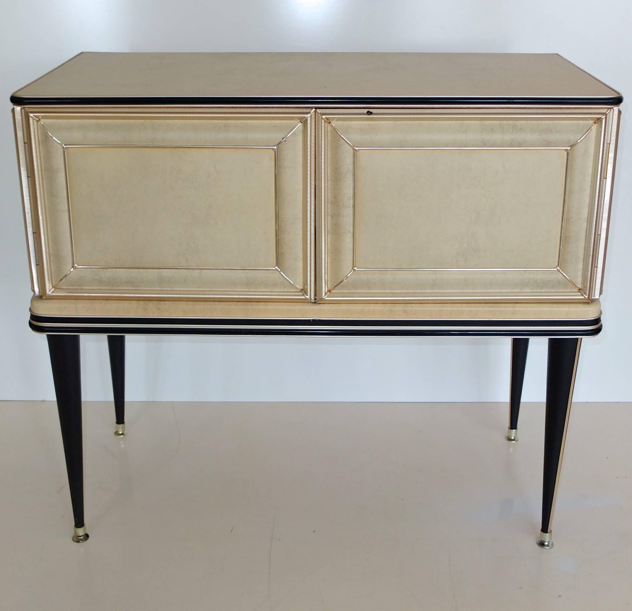 Early 1950s sideboard bar cabinet created by Umberto Mascagni of Bologna, Italy, imported to the UK by I. Barget and retailed through Harrod's, London, 1952-1955. Mascagni was known for his provocative use of new materials in furniture designs such