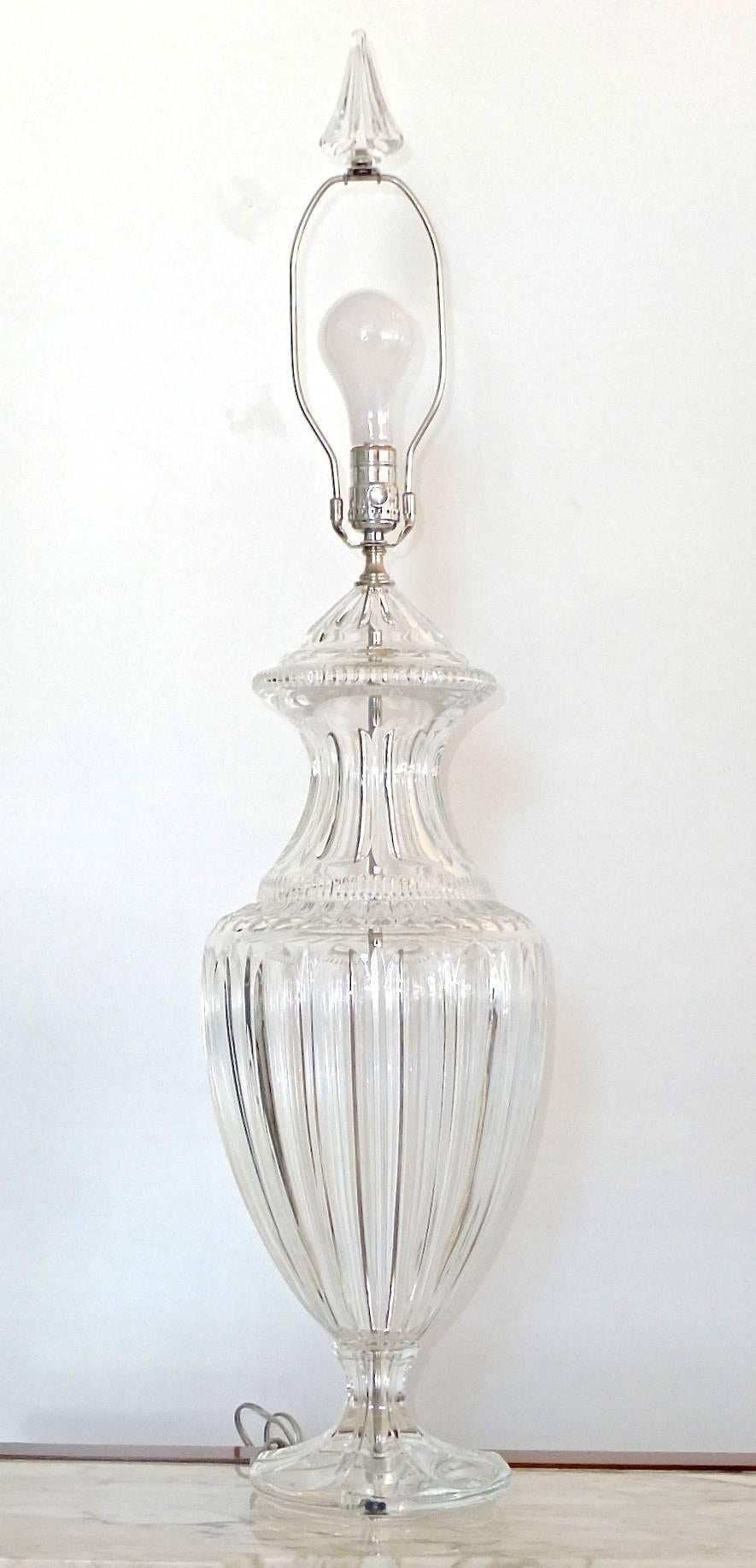 Pair of excellent lead cut crystal urn form lamps with crystal bases and polished nickel hardware and matching crystal finials. Probably Baccarat.

Measure: 24 inches high to the nack of the socket.