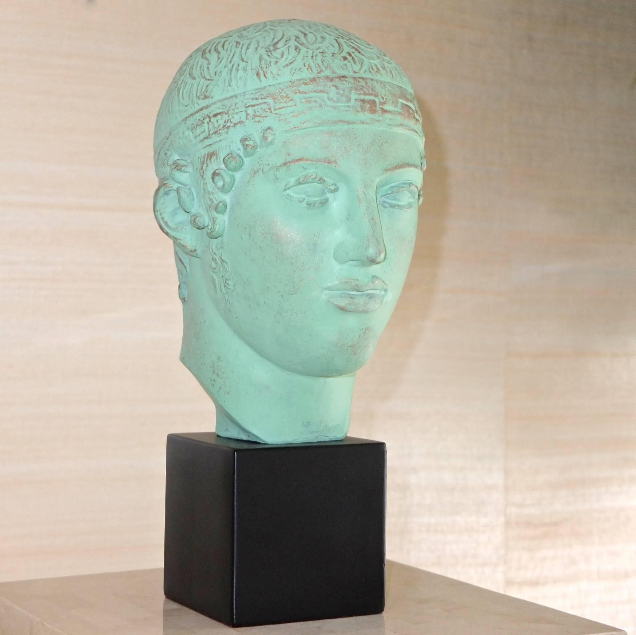 Alva studios replica Roman verdigris bust on solid block stand of young Roman man, circa 1980. Titled Head of a Charioteer.

Alva studios, formed by Virginia Morris Pollak and Alfred Wokenberg after WWII, created high-quality sculptural replicas