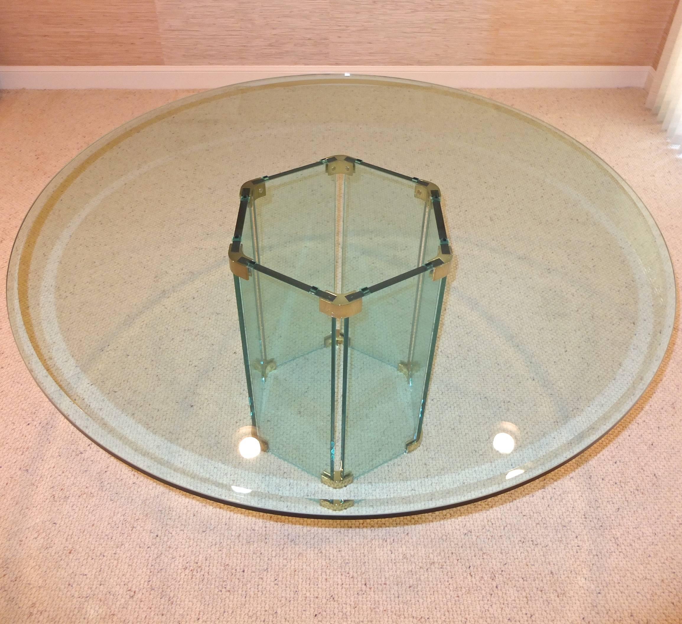 60 inch round glass top with 1 inch bevel and 5/8 inch thick tempered glass on a hexagonal pedestal base with six glass panel sides joined together by brass connectors. Excellent condition. No scratches or chips. Perfect for dining or game table.