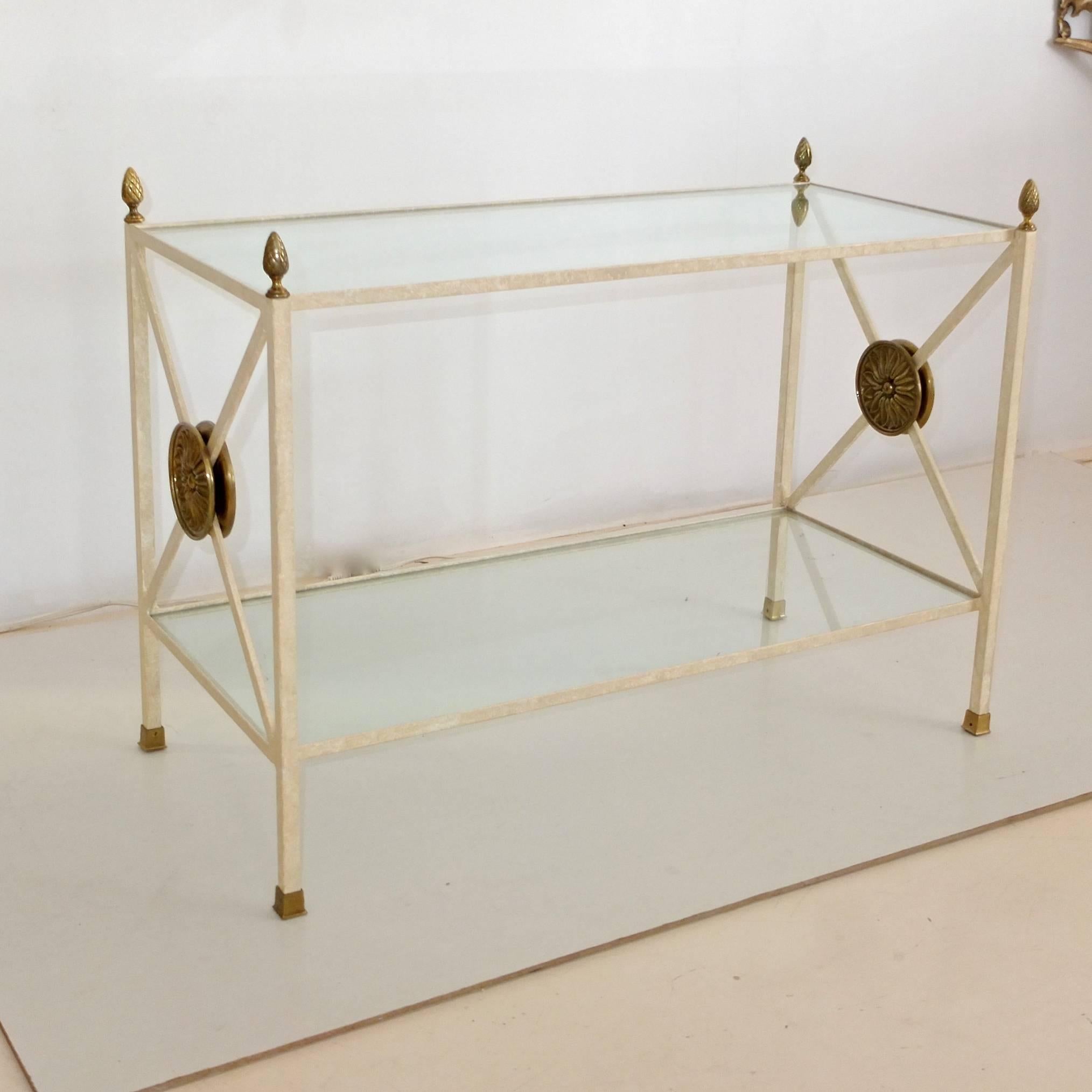 Custom-made, circa 1980 by a Boston area metal-smith. Directoire form two-tier rectangular end table étagère constructed of welded iron, two inset glass shelves flanked by X supports with large round brass embellishments. Four brass pinecone finials