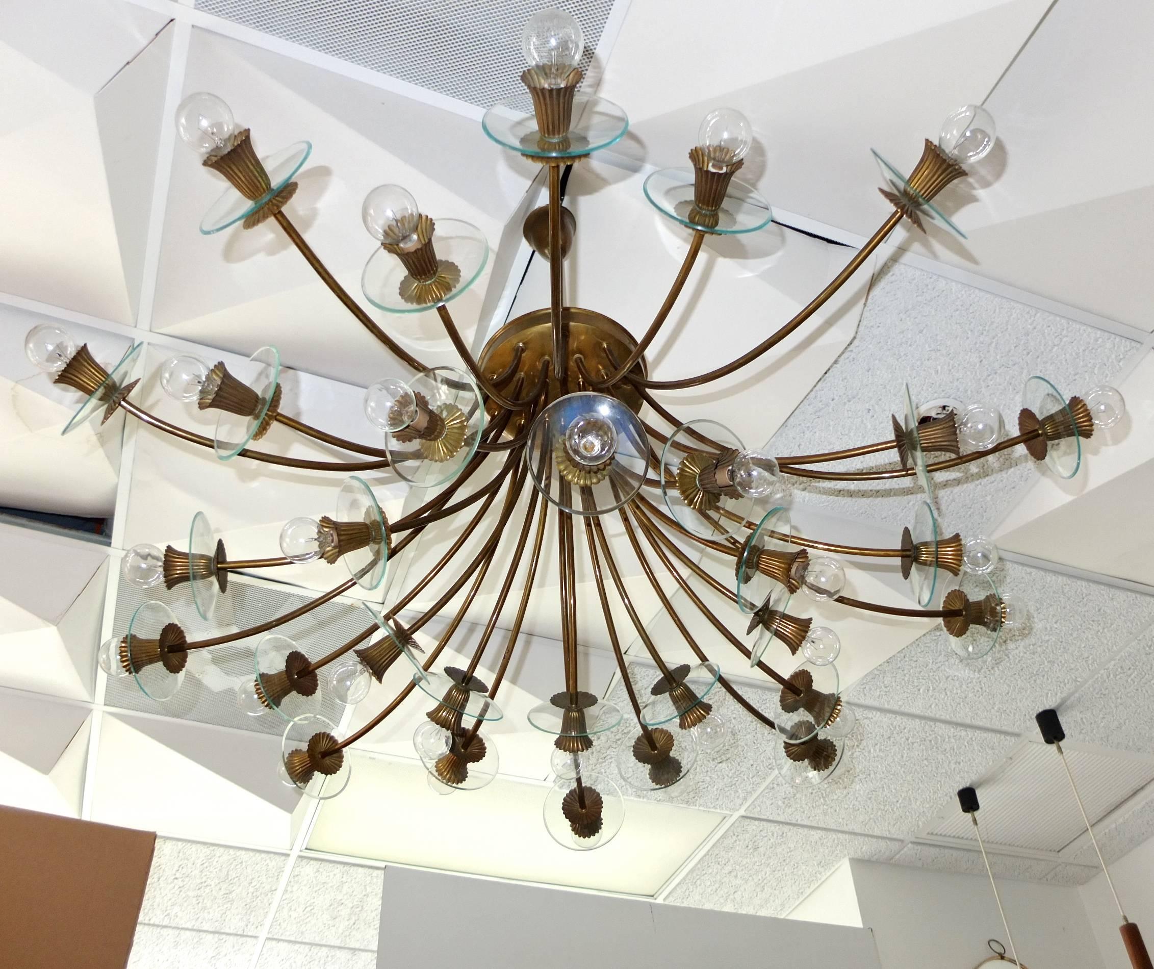 Monumental scale chandelier or ceiling flush mount light fixture made in Italy, circa 1940 in the style of Pietro Chiesa's inverted bouquet for Fontana Arte, 1938. 

Thirty curved bronze finished tubular stem-like arms, three sets of ten of three