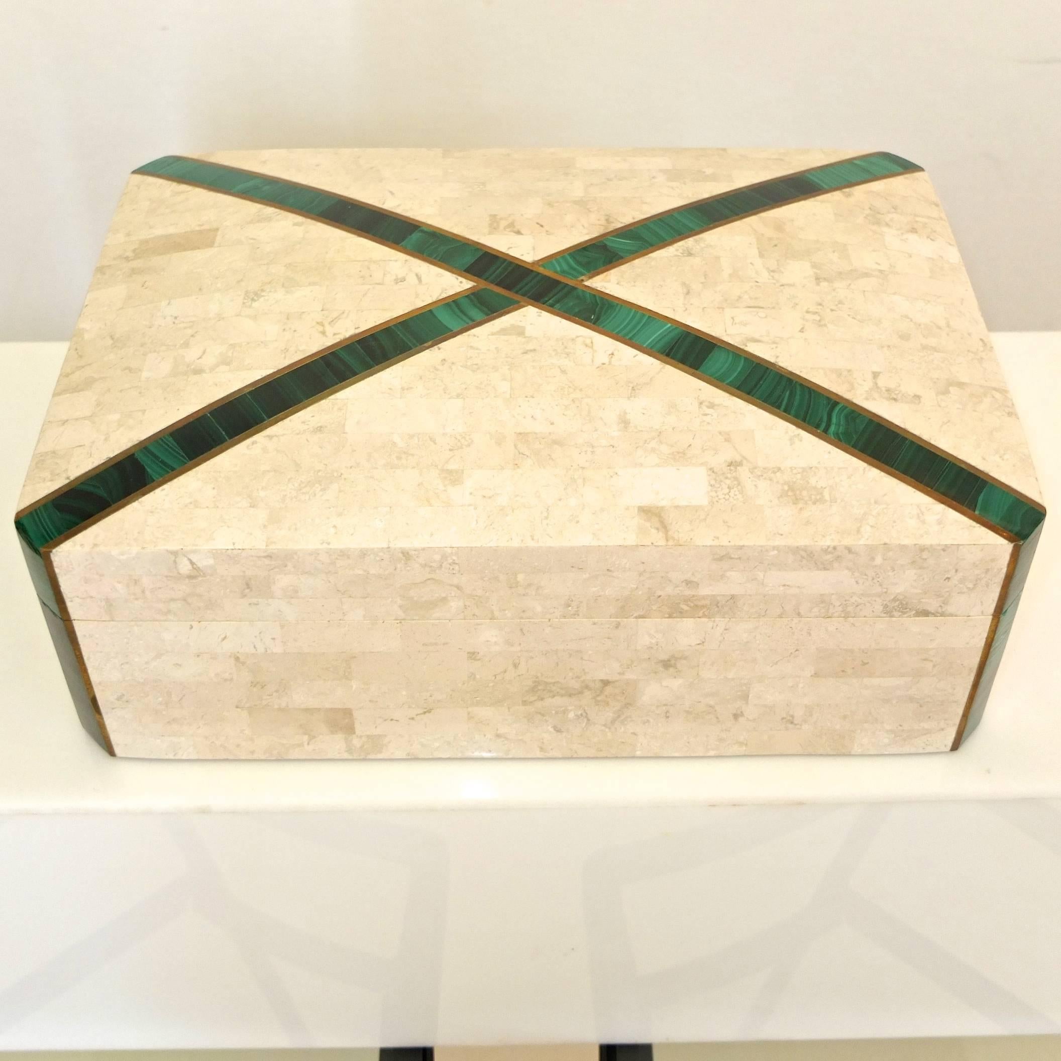 Two in one. Large hinged lidded box with brass inlay and what appears to be malachite. Wood lined. Suitable for use as a humidor or jewelry box.

Surprise: inside is a second smaller box, lidded, wood lined, suitable for cigarettes or cards. 3.5