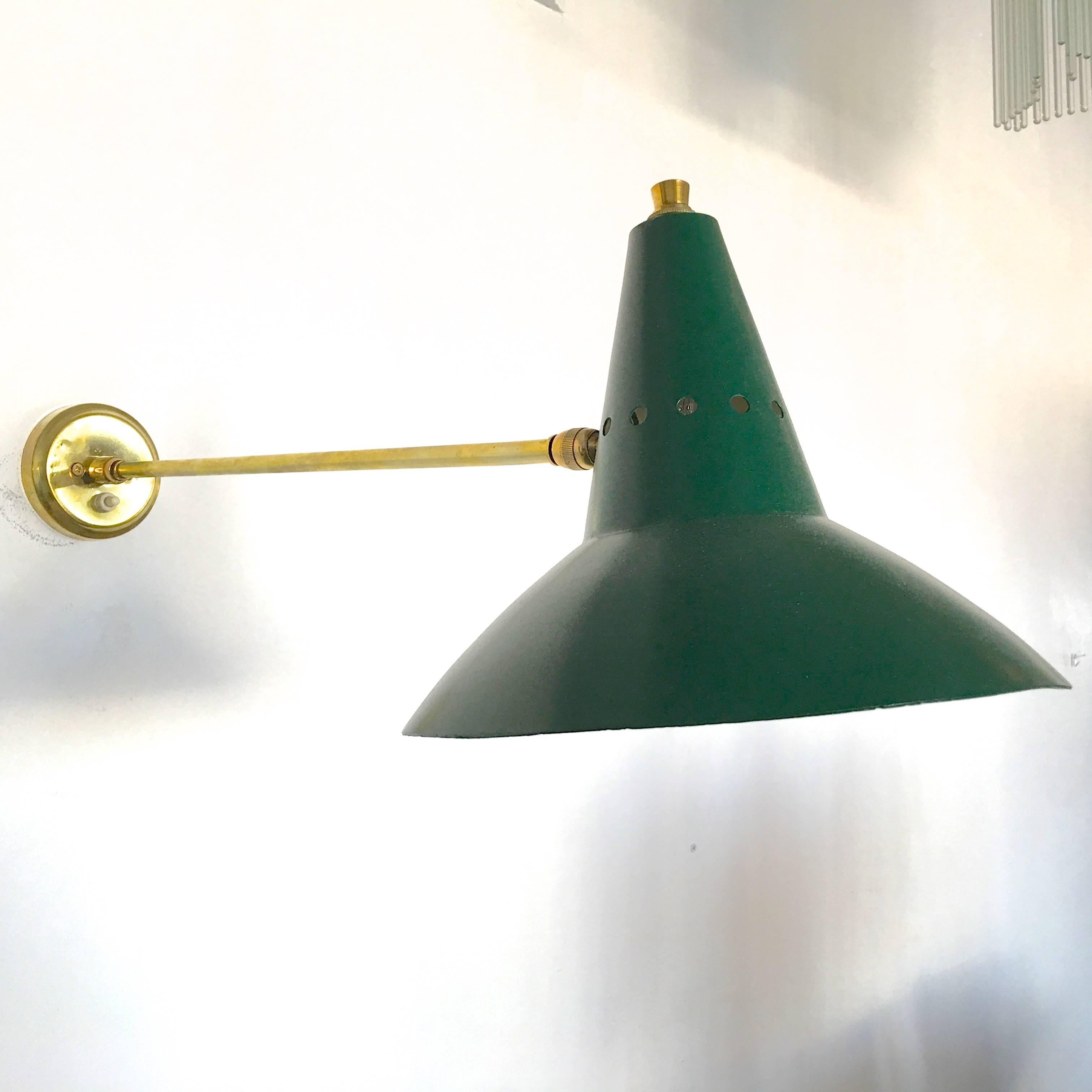 Stilnovo wall-mounted lamp with long brass arm perpendicular to the wall and articulating dark green aluminium shade. Push button on-off switch on mounting plate. Rewired for USA with a single E12 socket for a candelabra size bulb up to 75