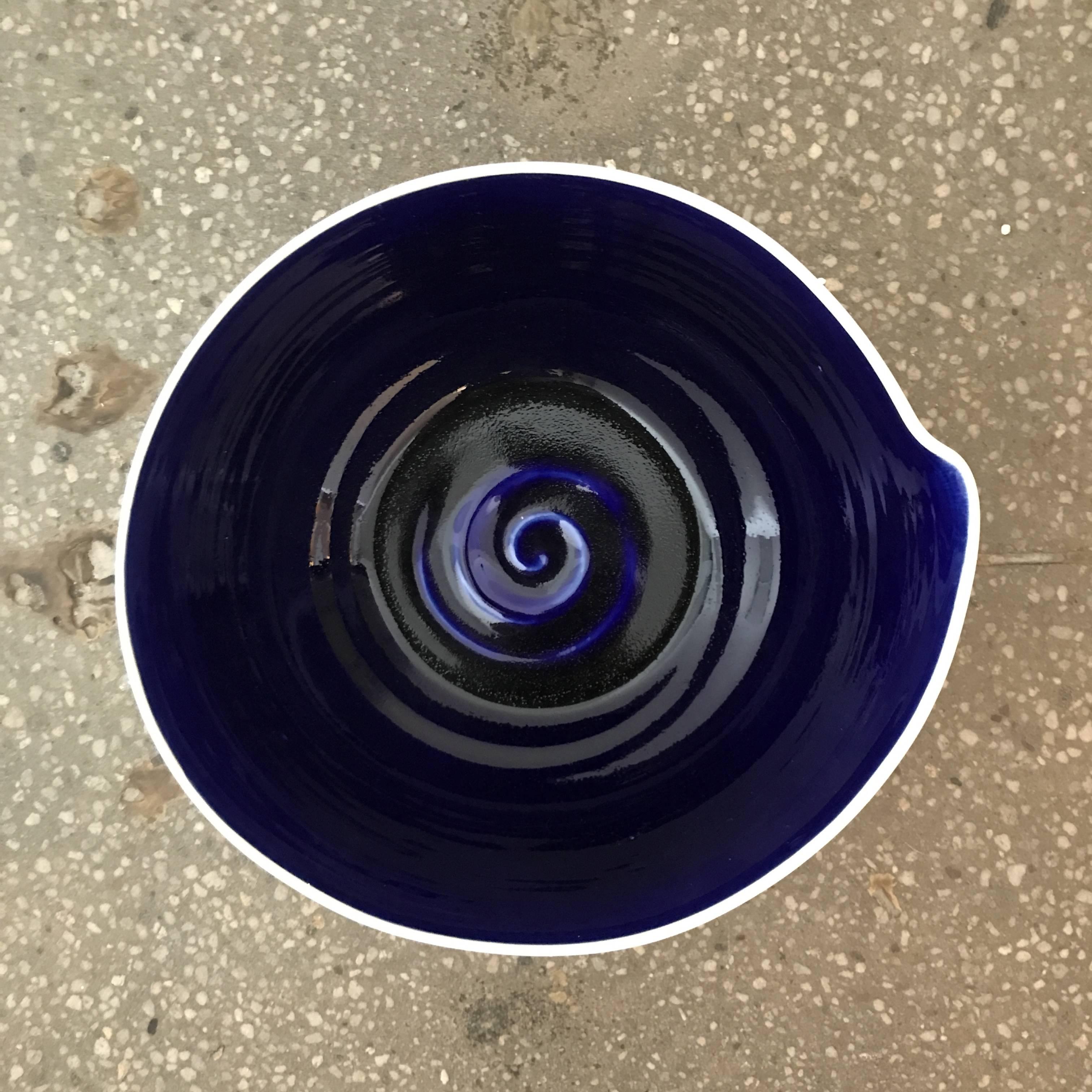 Hand-thrown blue and white ceramic studio pottery bowls created by a local artisan in Jaffa Israel. 
Indigo blue interior with white exterior. Subtle bend detail on the rim of each bowl. Intricate graphics and artist signature on the bottom. 11