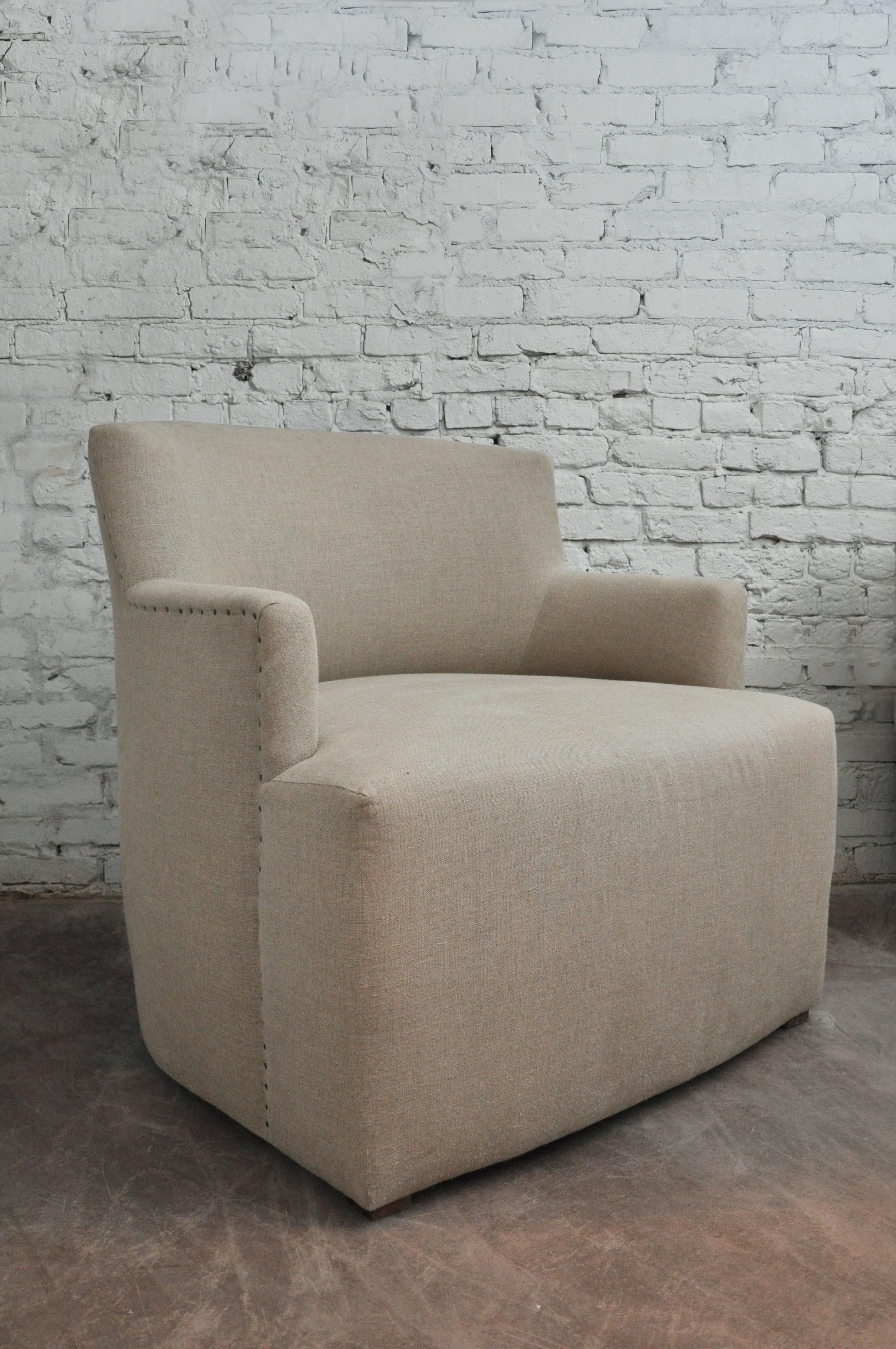 Mid-20th century Italian club chair, circa 1950s. Oversized, modern design. 
Vintage but newly upholstered in flax colored Italian linen with nailhead detail. 
this chair is cool and unusual and very comfortable  

Dimensions: 35" H x