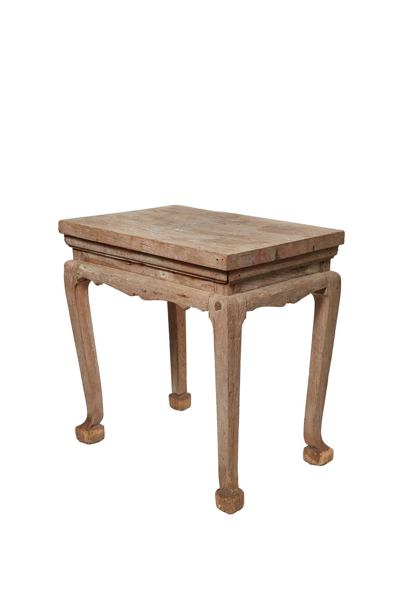 19th century bleached wood Thai table. Handcrafted with a Classic decorative detail on the apron and legs. The top is worn from years of use and finish appears to have been worn off or bleached.  Beautiful patina 