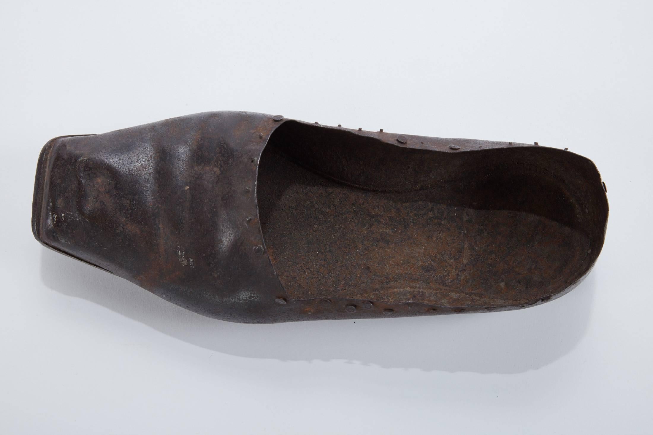 Late 19th century hand-forged iron shoe, likely a Conblers sample.
   