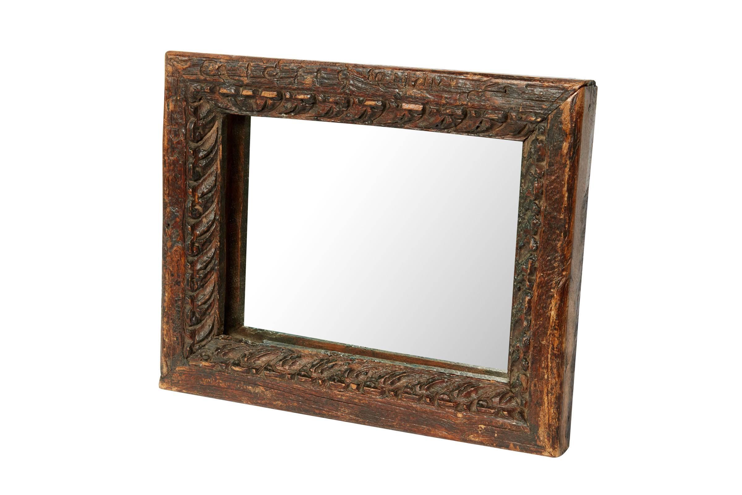 20th century hand-carved wooden mirror from Indonesia.