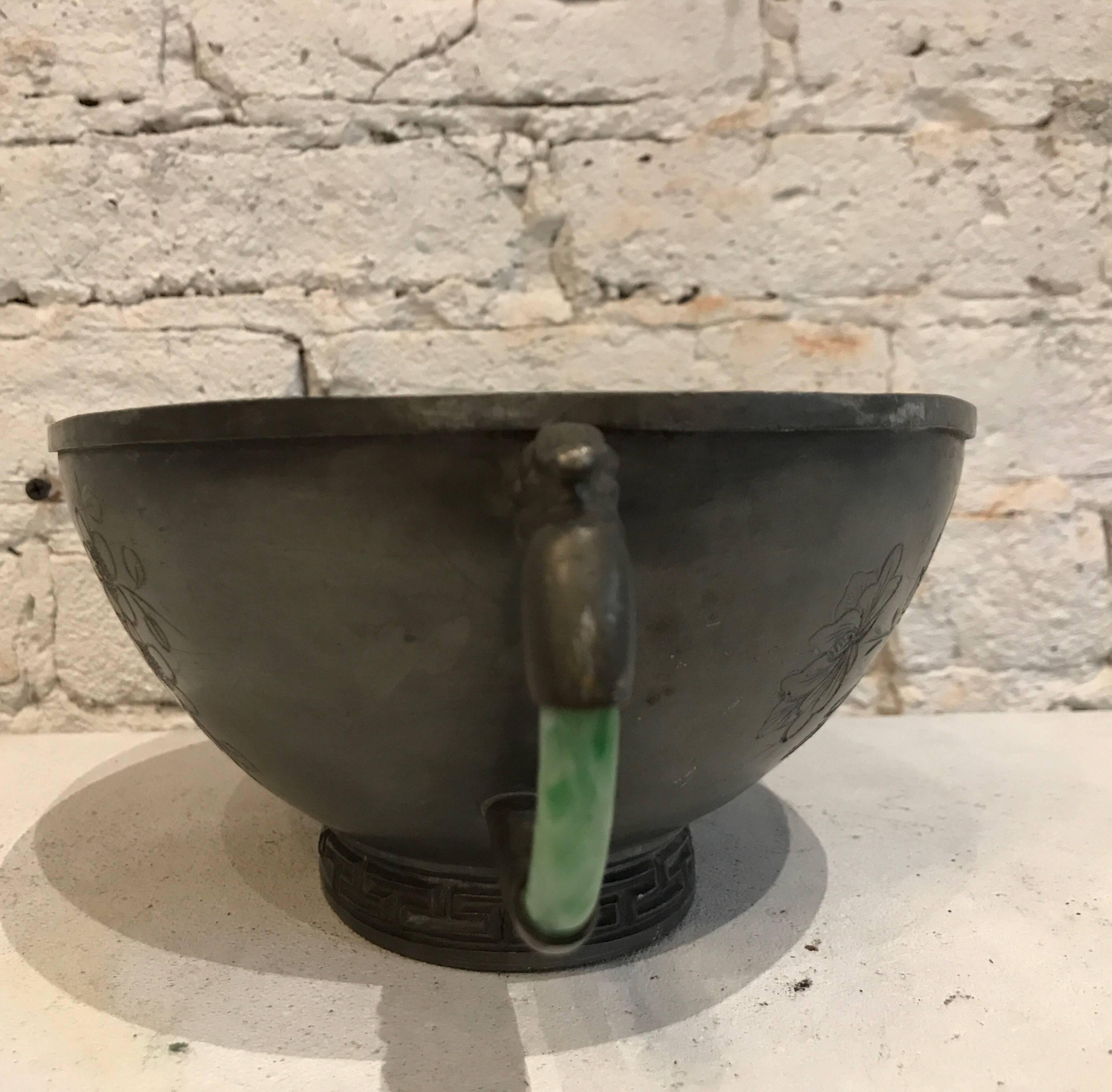 Early 20th century pewter/jade handled Chinese cachepot 
This lovely piece has classic engravings and jade handles



Measures: 10.5 inch W (including handles) x 7.25 inch D x 4 inch H
Actual Pot: 8.5 inch W x 7.25 inch D
Bottom of pot: 4.25