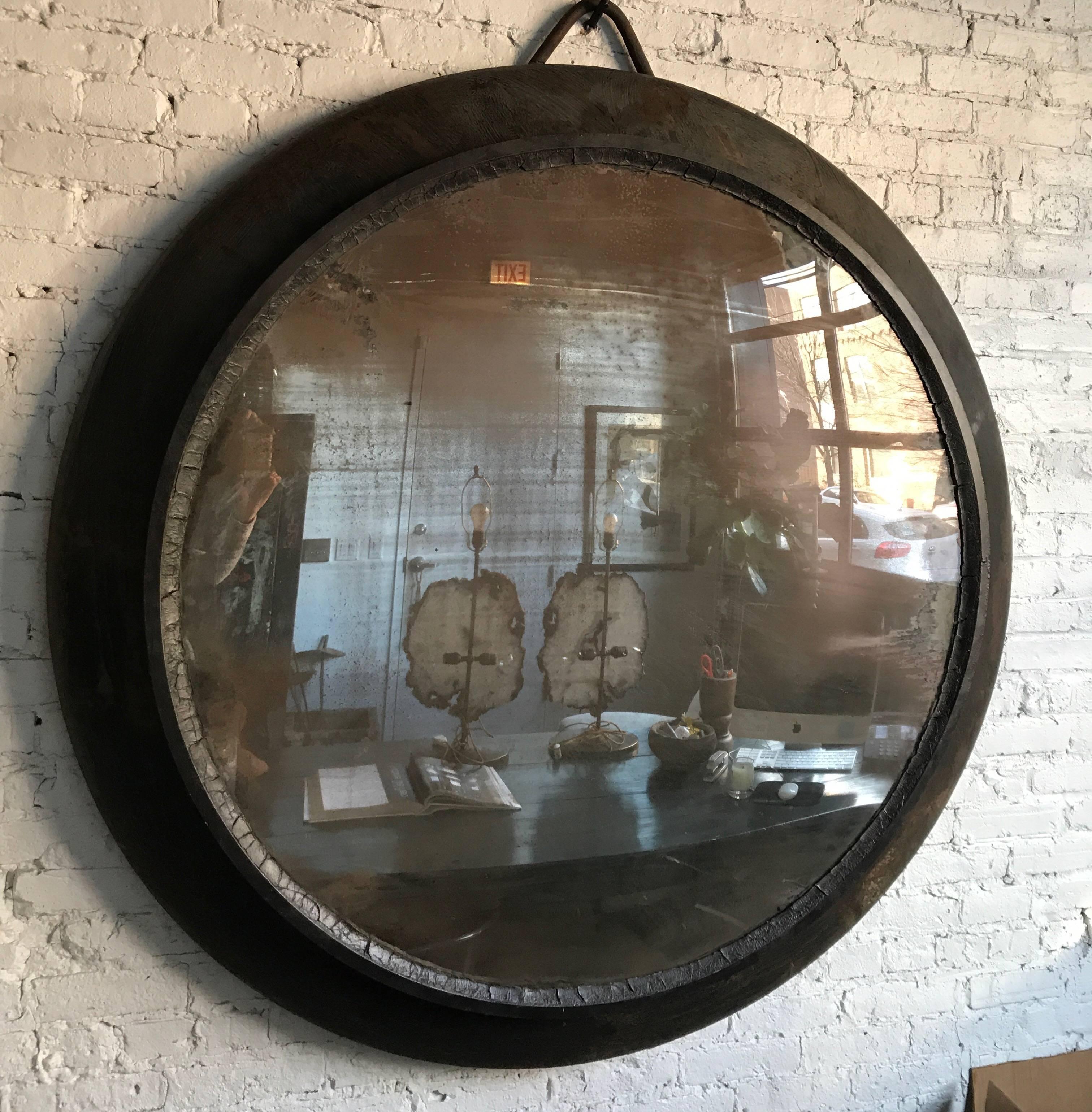 Early 20th century oversized European metal framed convex mirror.
This mirror is larger than most on the market today. The frame is thick and hefty which adds to the overall look of the piece. Frame is textured in shades of black.
Measures: 60