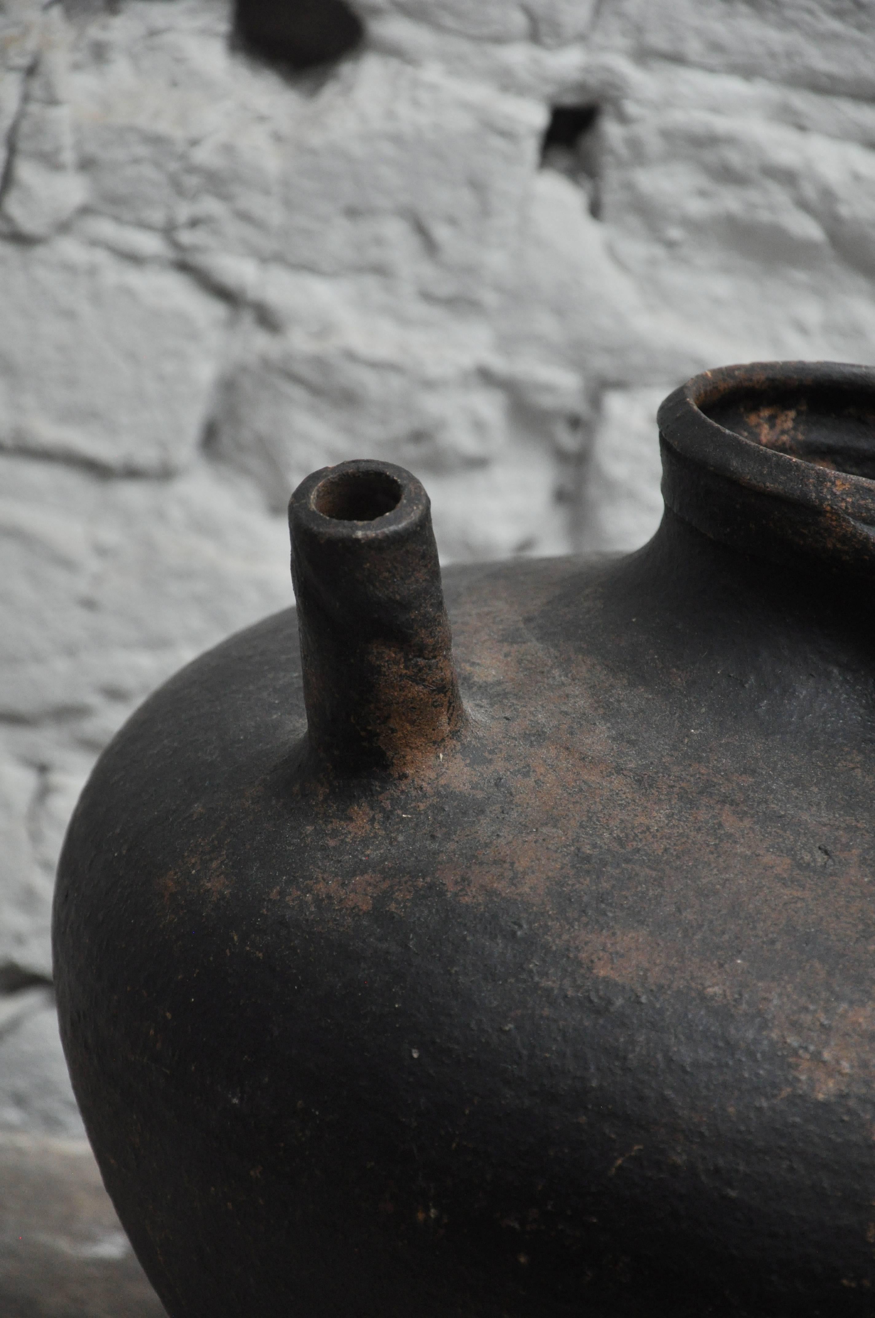 Early 20th Century Spouted Blacked Pot From Paris
This pot has a primitive quality. Most likely used in the countryside for its functionality.
Could be Asian, although found in France.

Dimensions: 12" diameter x 12"h