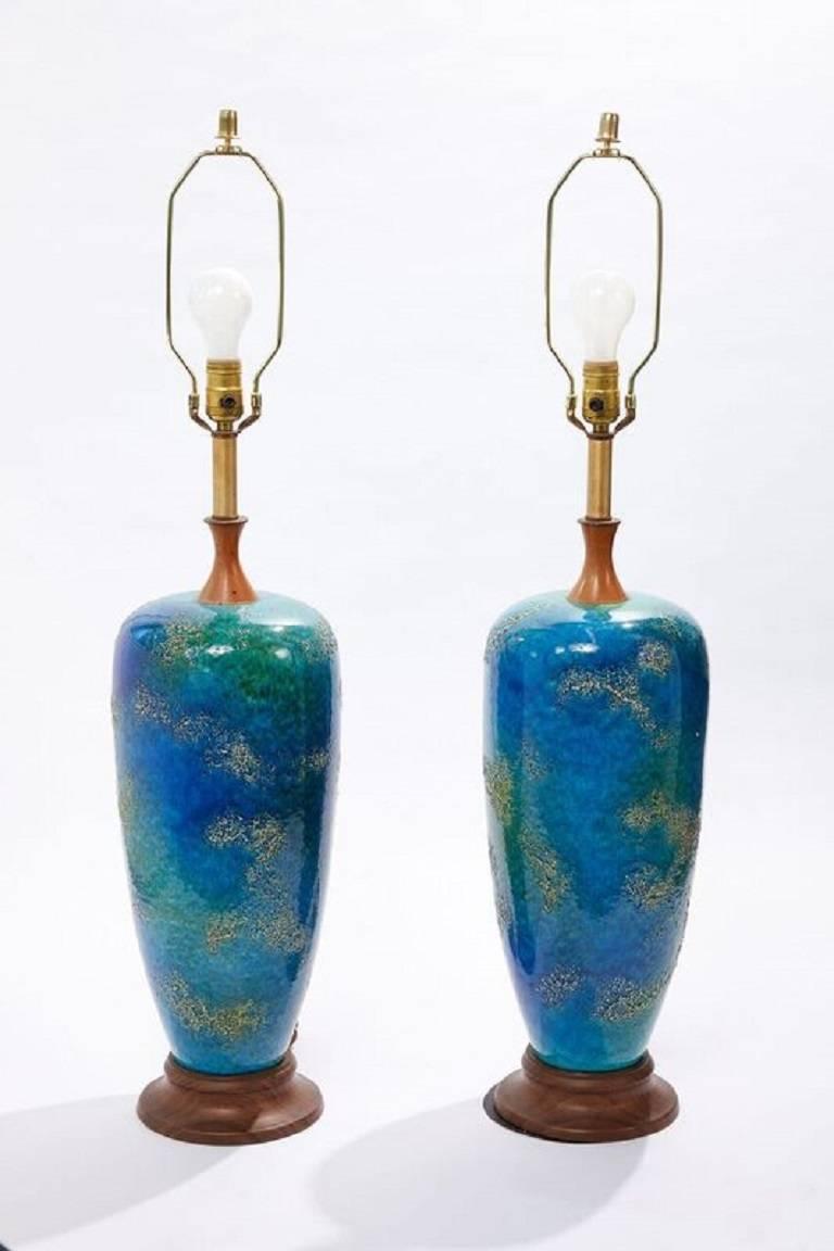Pair of American midcentury blue glazed ceramic lamps with custom shades
 

Dimensions:
Lamps with shades are 37.5 in. H x 15.25 in. W
Lamp is 37 in. H (including harp) x diameter of 8 in. at the widest part of the lamp
Base has 7.25 in.