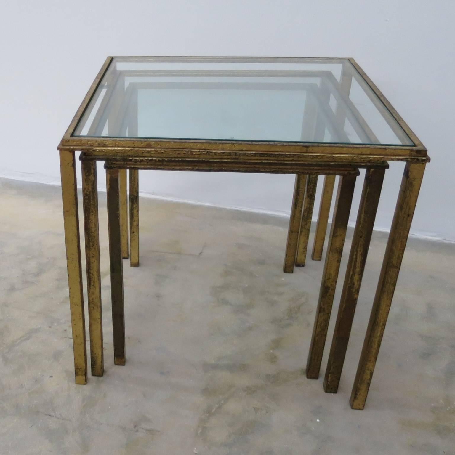Gogeous gilded set by Roger Thibier designer .
 gilt wrought iron nesting side tables with glass top (a total of 6 items.) 2 set of 3 items .
Mid-Century Modern period.
Dimension for each one
11