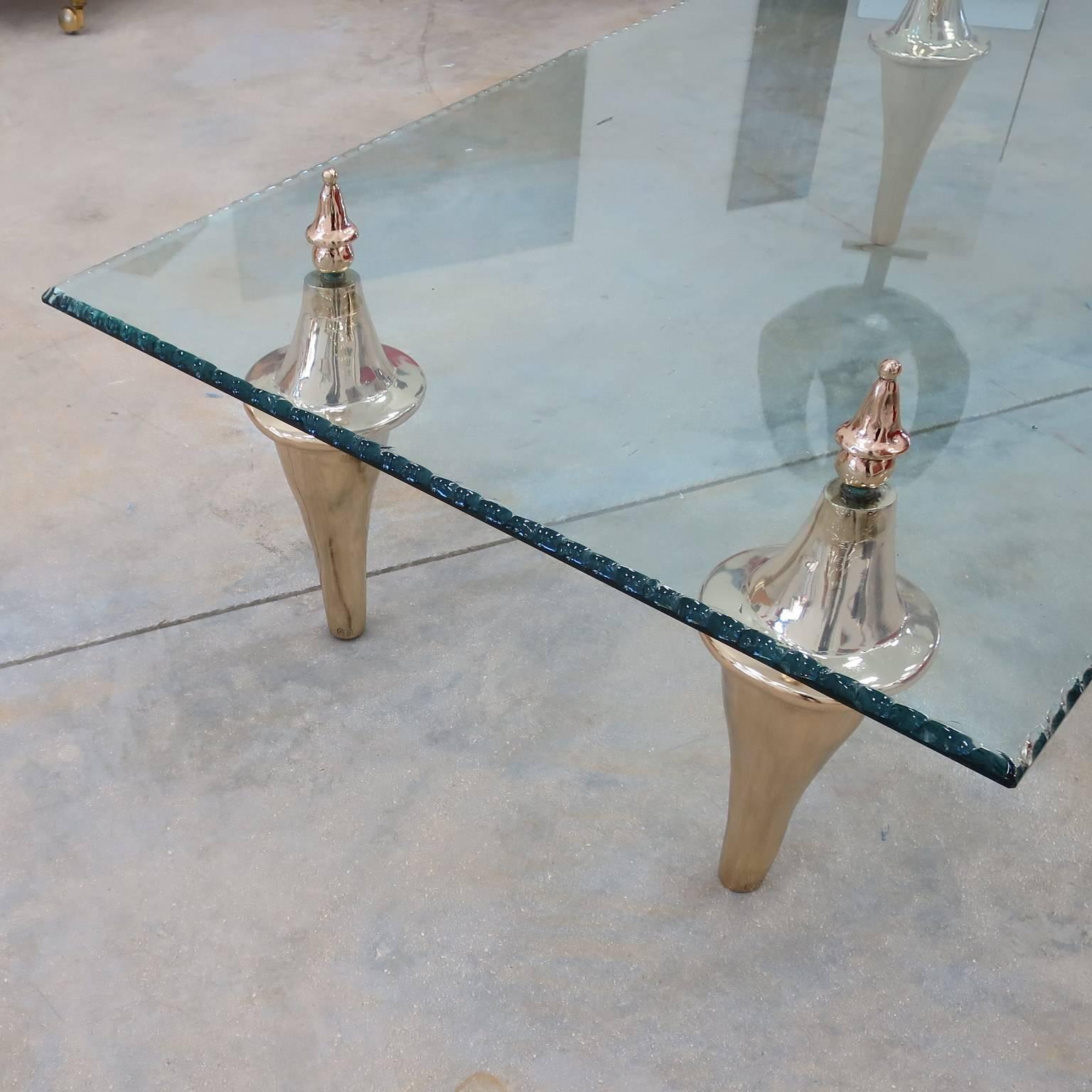 Rectangular low table .
Four  bronze feet , each one is signed .
Thick cristal glass top .

impressed signature on each leg: (B.G) 1988.
  