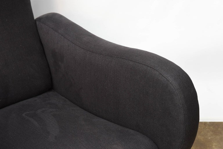 Mid-Century Modern Italian design armchairs, recently reupholstered. 
The general design is elegant, the seat is extremely comfortable.
Very interesting look from the back as well.
 The charcoal color of the fabric is matching perfectly with the