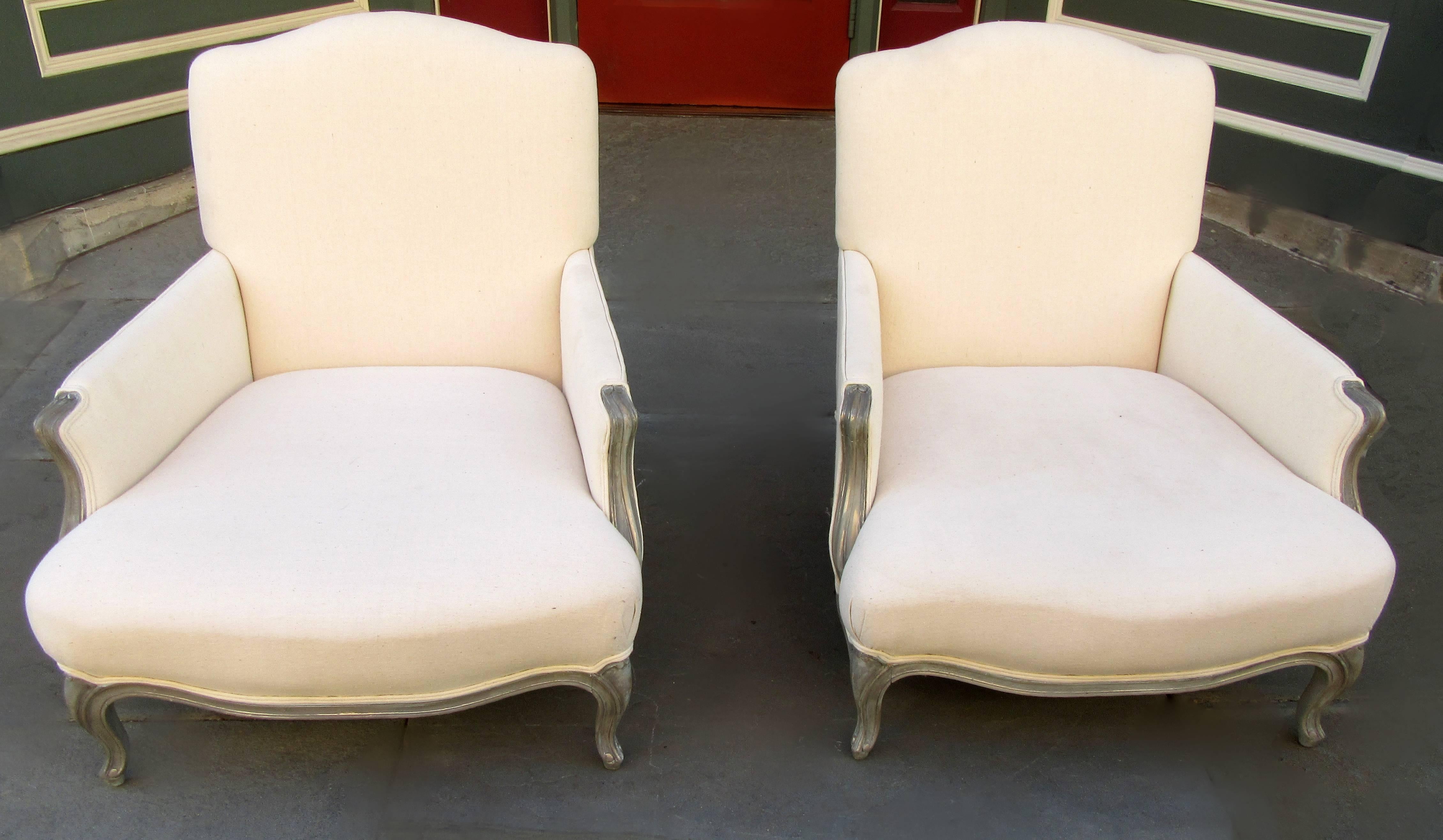 A pair of larger-scale French chairs in the Louis XV style, painted and newly upholstered in white cotton duck, circa 1900.