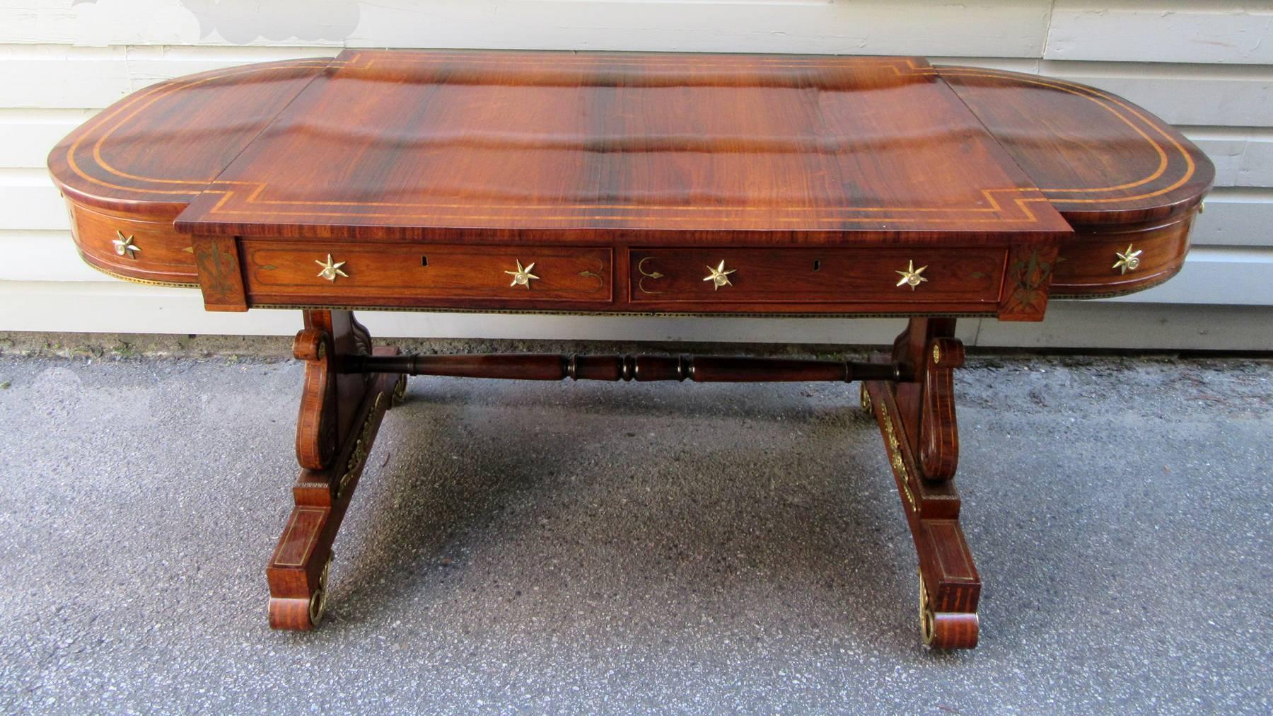 A spectacular English Regency rosewood sofa table attributed to acclaimed cabinet maker 
