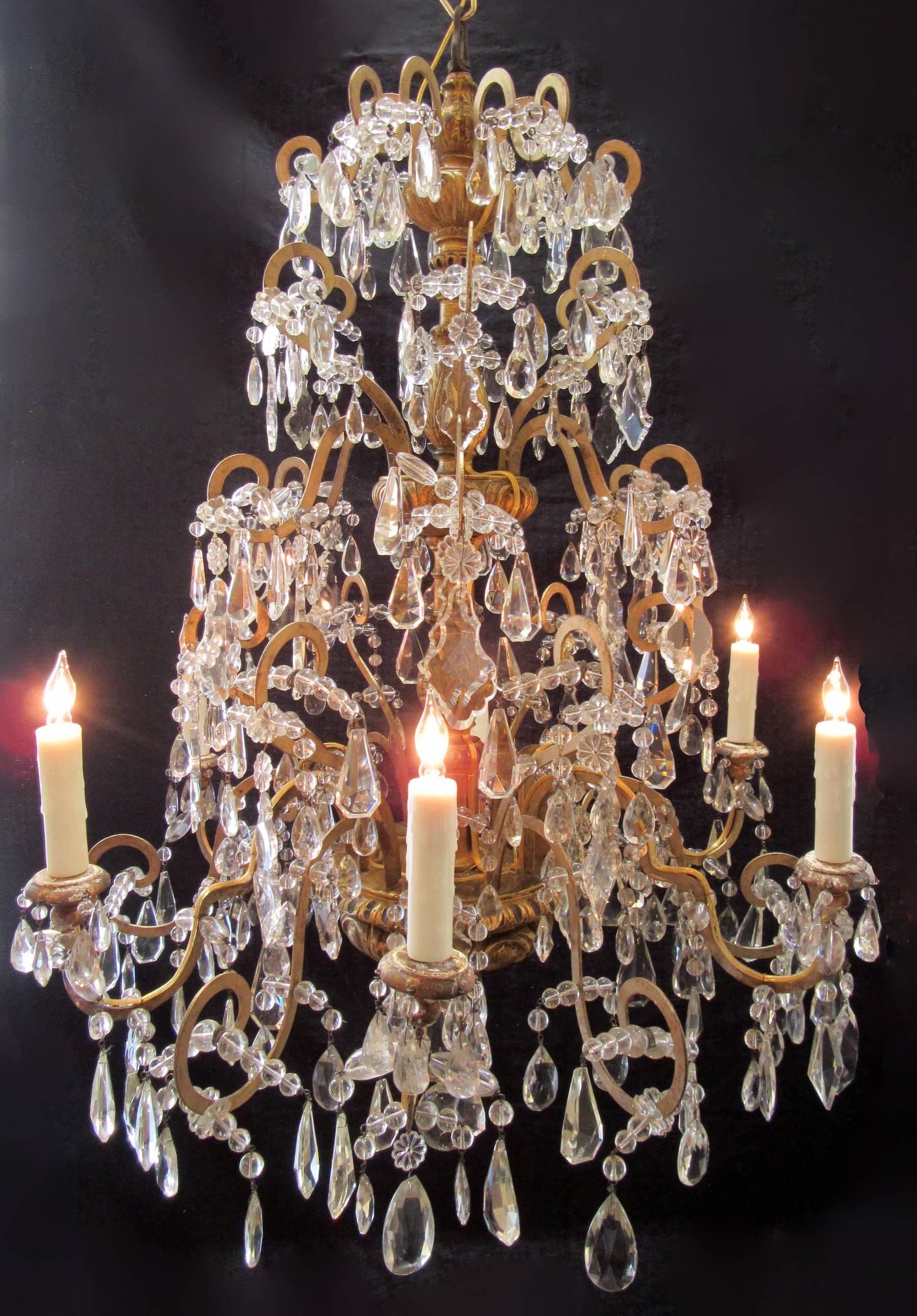 An elegent Genovese chandelier with a finely carved and gilded stem with original crystal, circa 1780. Fully restored with new wiring and porcelain sockets.