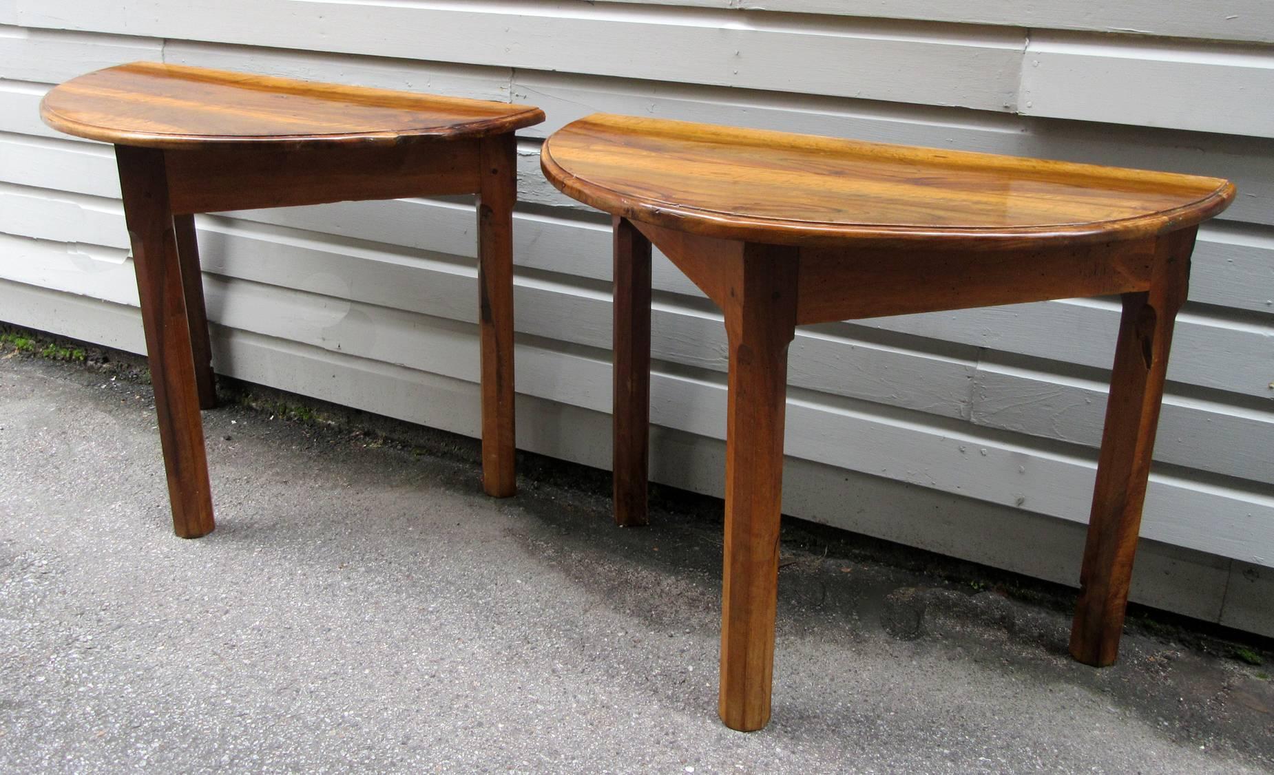 A pair of French provincial fruitwood demilune tables most likely made of olivewood, circa 1790. With excellent cognac color and a French polish finish.
