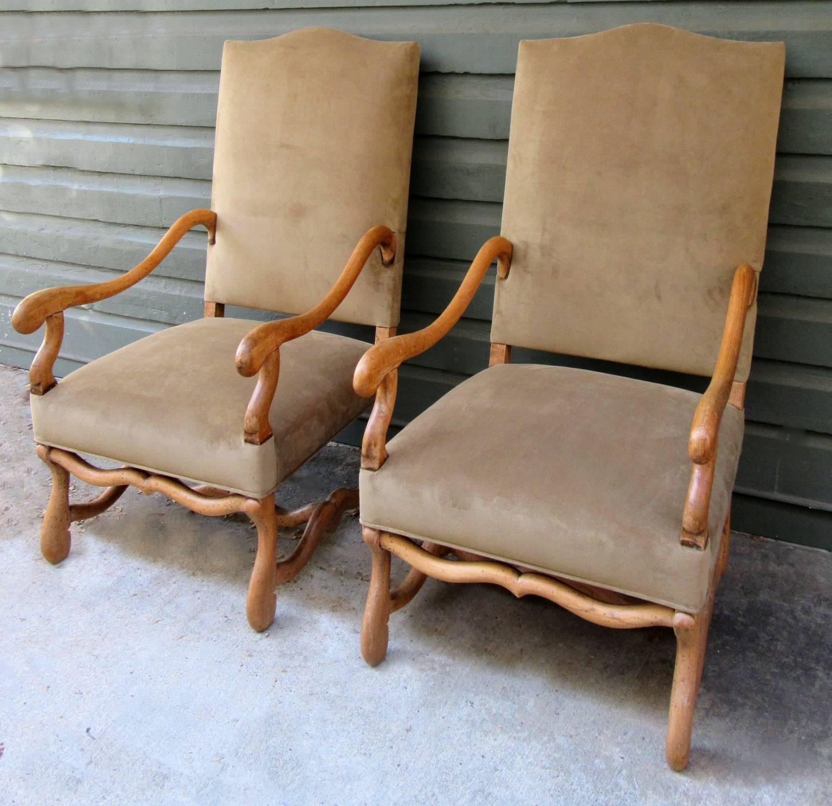 A pair of larger scale French armchairs in Louis XII style, circa 1820, featuring solid fruitwood frames that have been recently reupholstered in a rich camel colored sueded silk.