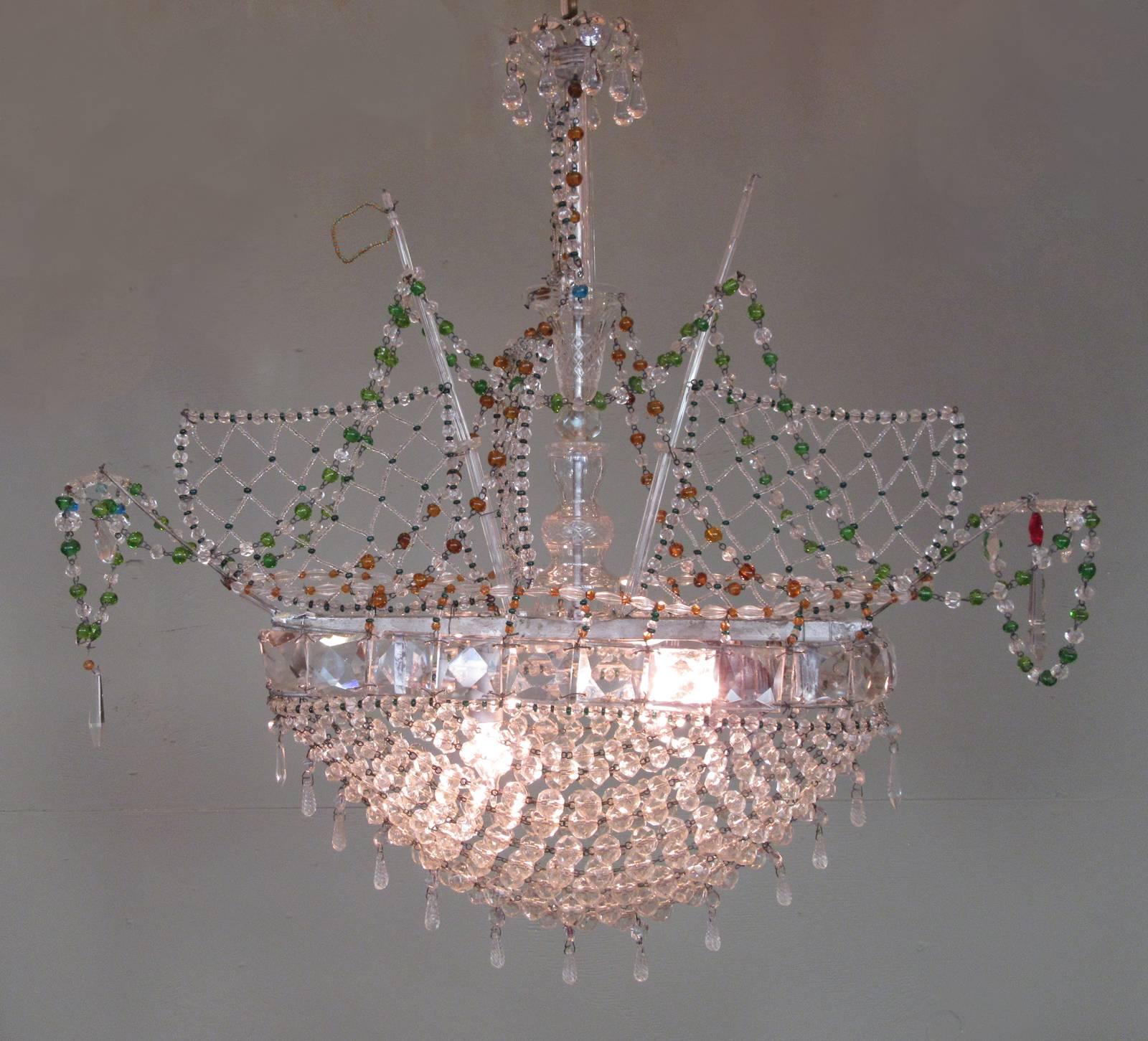 A smaller scale, Venetian crystal ship chandelier, circa 1910, featuring green, blue, orange and red crystals accents on the ship's sails. Recently rewired with new porcelain sockets.