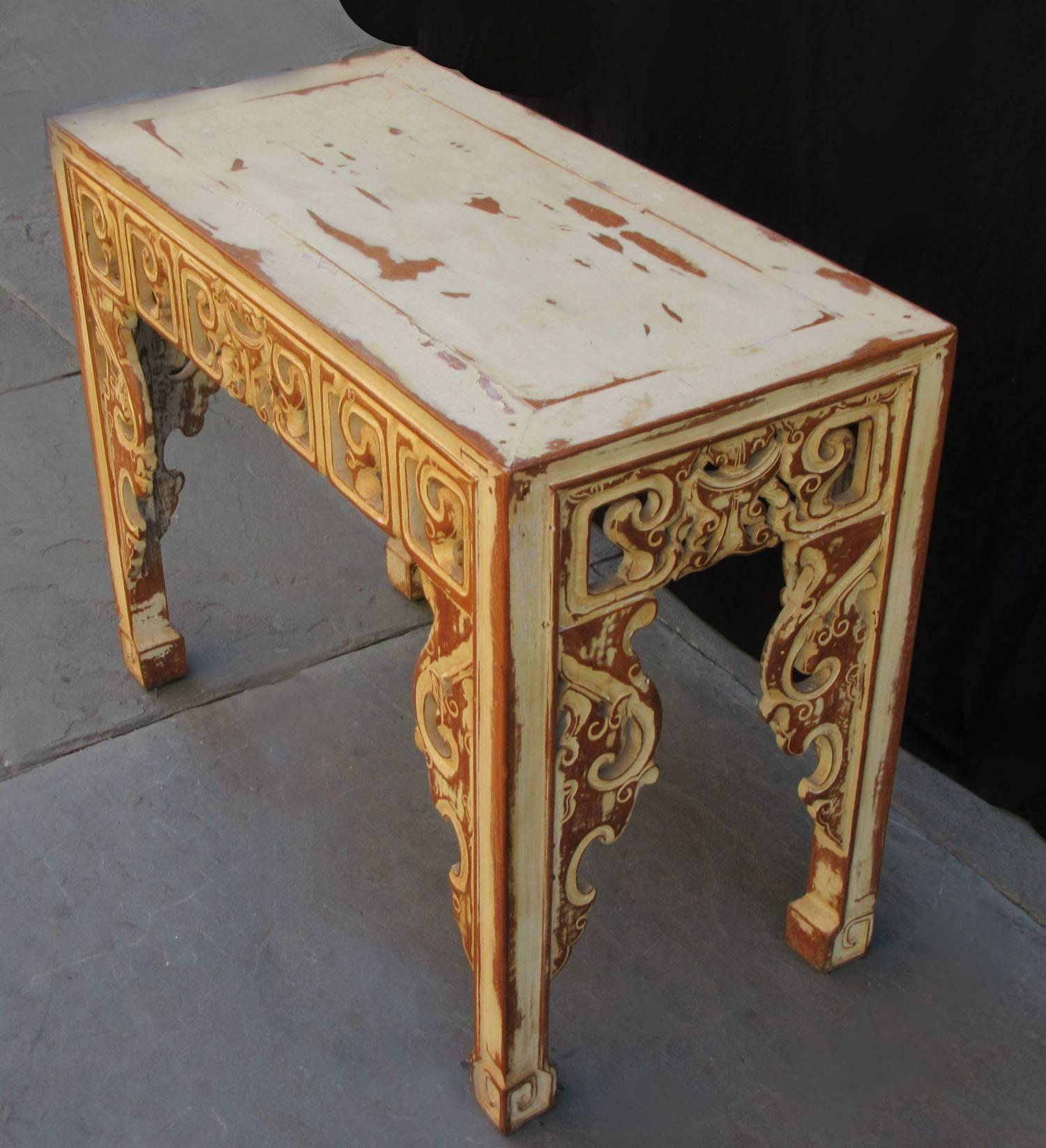 A pair of Asian altar console tables, circa 1920, with distressed cream paint finish.