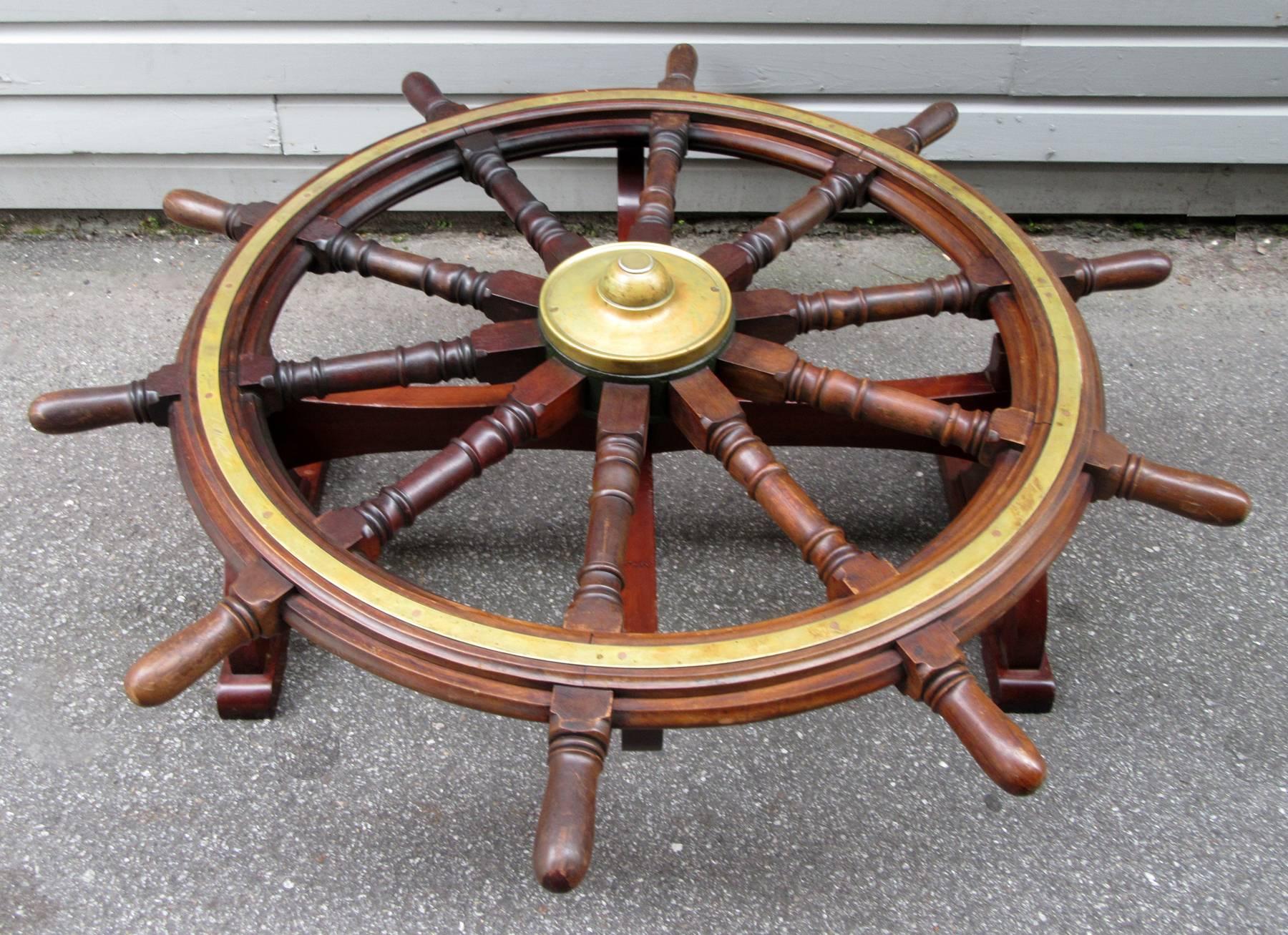 An authentic English mahogany ship's wheel coffee table, circa 1780, with custom mahogany base and glass top. Provenance: Purchased from private collection previously on loan to a Florida maritime museum.