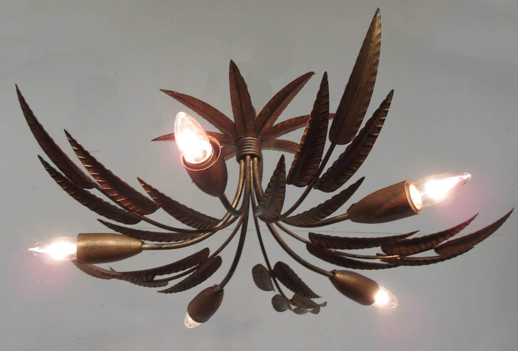 A medium sized Barcelona gilt tole chandelier, circa 1940, featuring free-form leaves and five candle bulbs. Recently rewired.