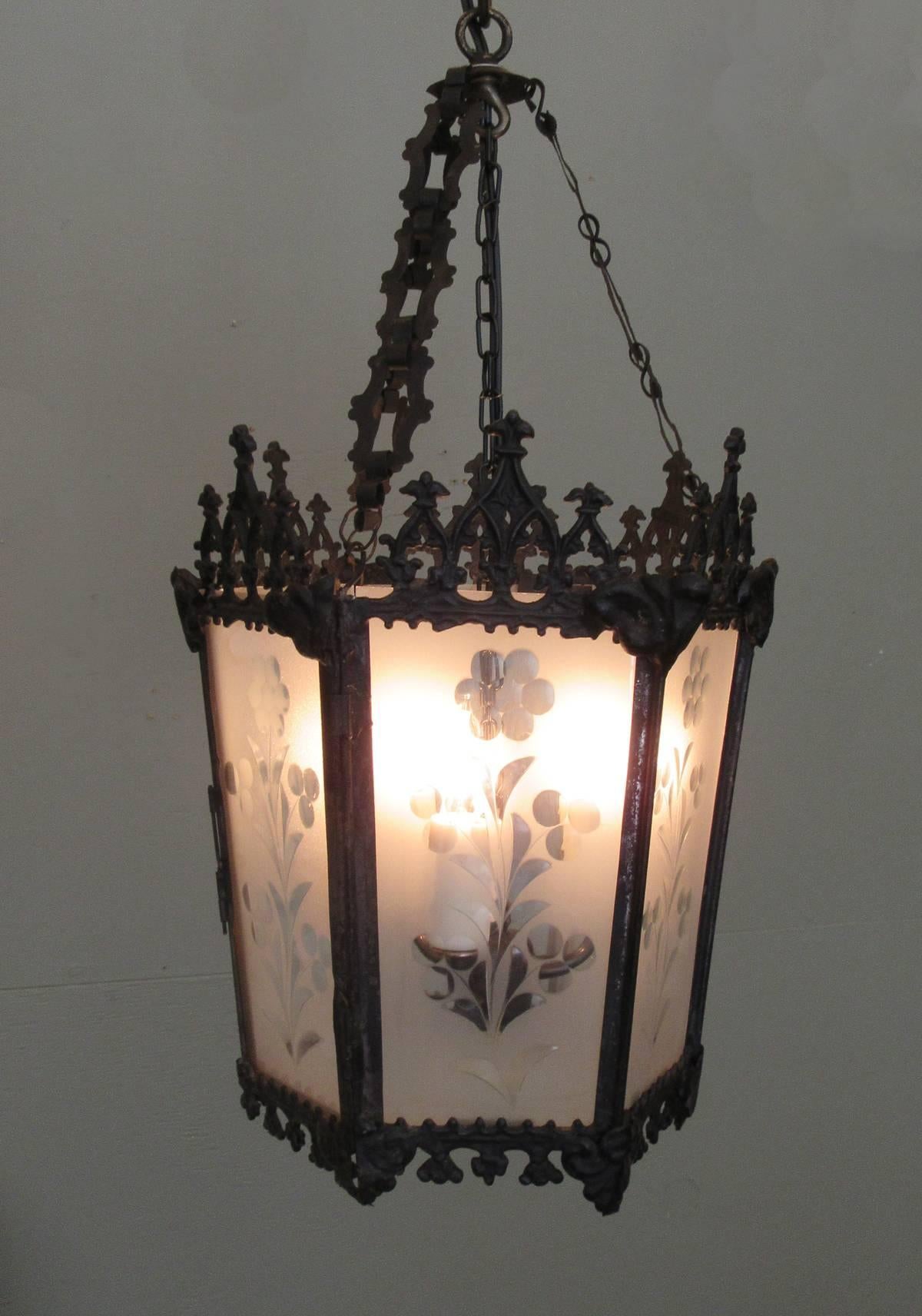 A Gothic lantern from New Orleans, circa 1850, featuring ebonized brass frame, etched glass panels and three candle bulb pendant. The fixture was originally candle but has been recently rewired for electricity with new porcelain sockets.