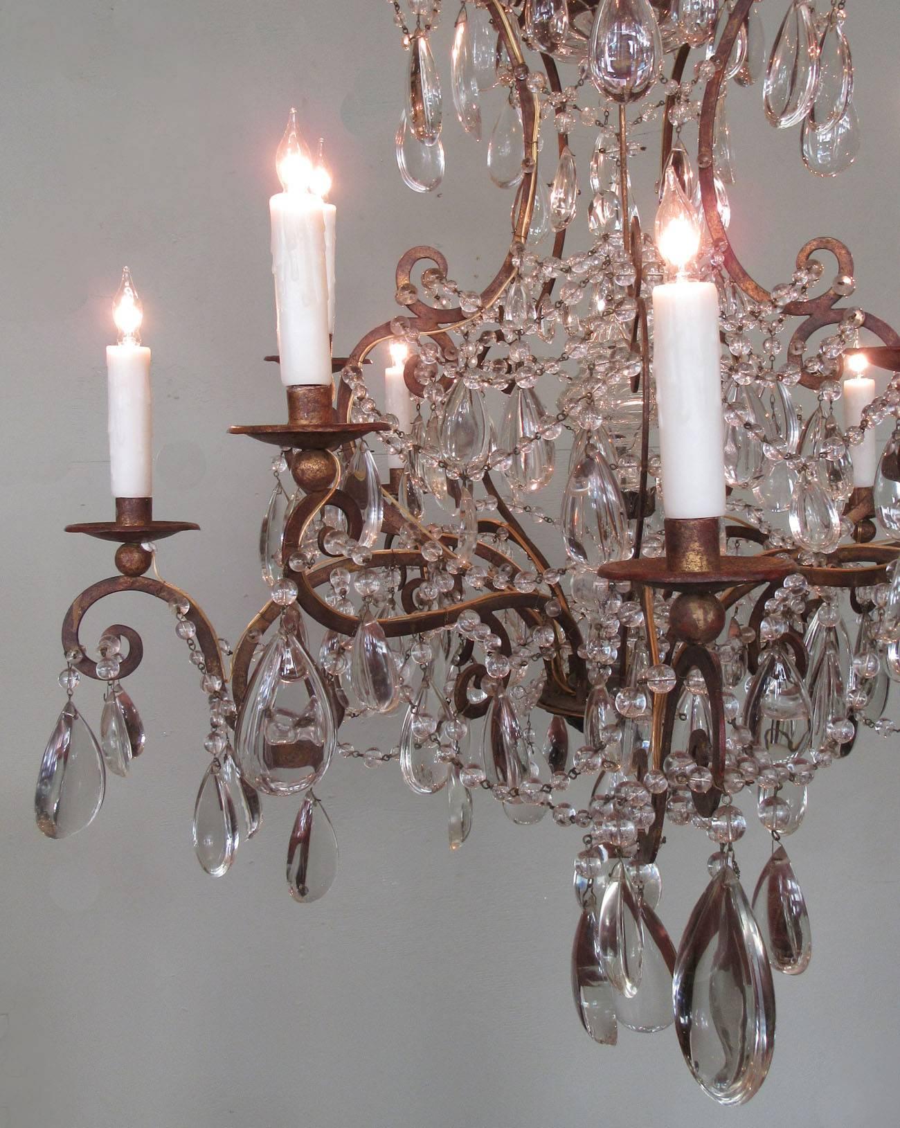 A pair of Italian piedmont gilt tole, beaded crystal and polished crystal pendant chandeliers, circa 1820, featuring ten candle arms. They have been rewired with new porcelain sockets and are available for sale individually or as a pair.
