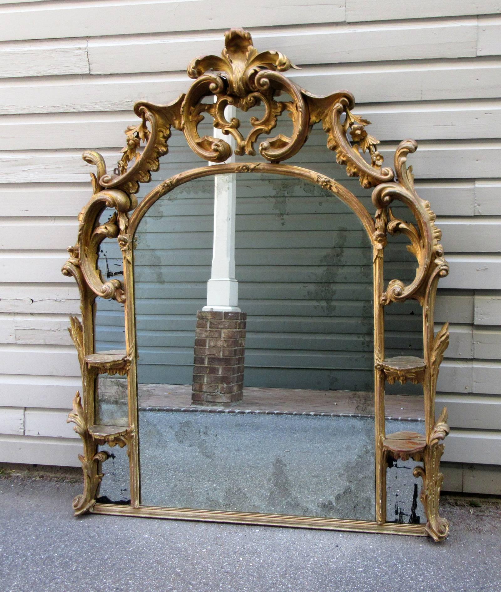 An English chinoiserie style giltwood overmantel mirror, circa 1780, featuring four display brackets and original mirror plate.