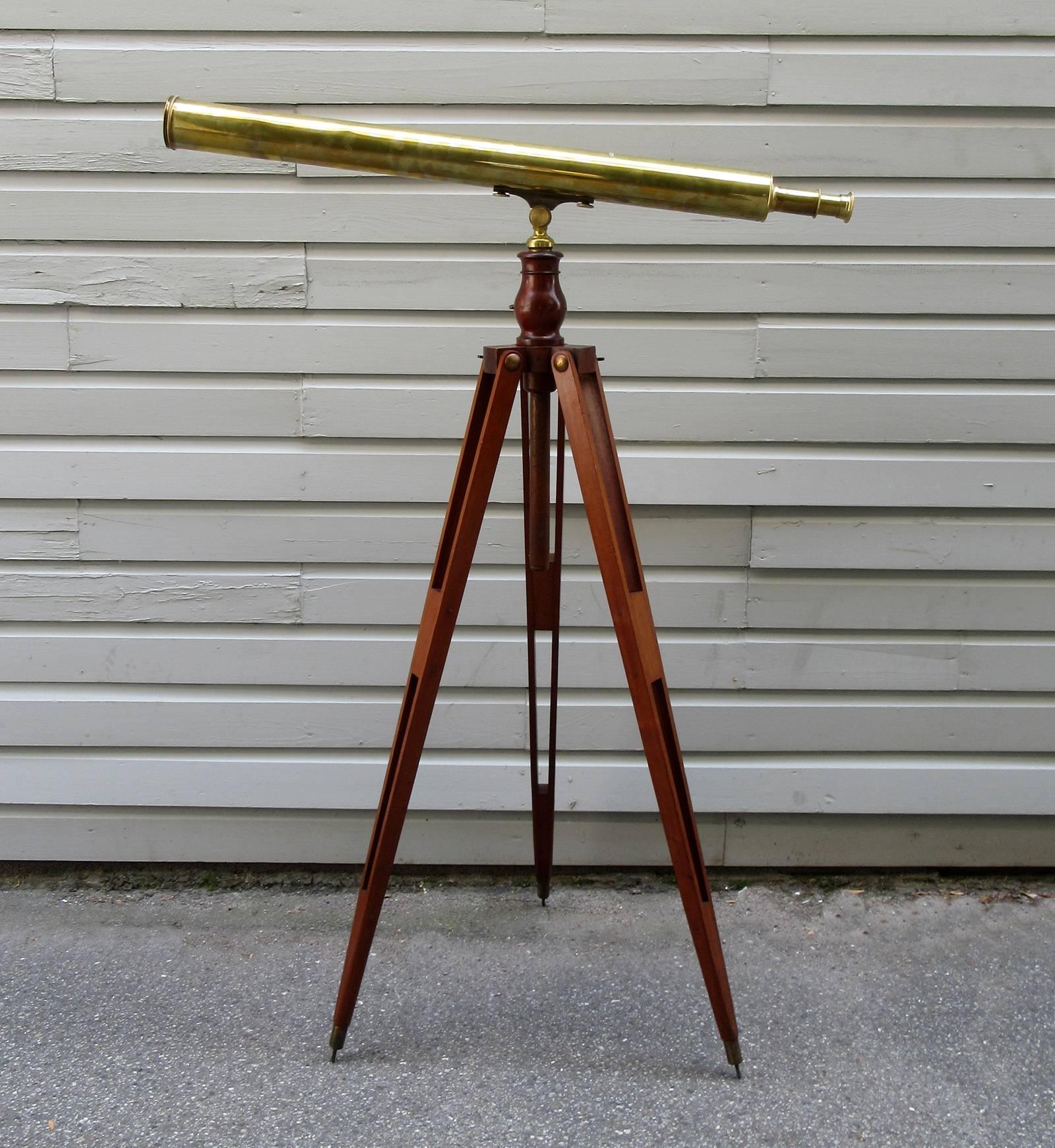 A high-end brass French telescope from maker E. Vion of Paris, circa 1880, featuring a mahogany tripod stand and ten additional lenses with original box. The closed telescope alone measures at 43