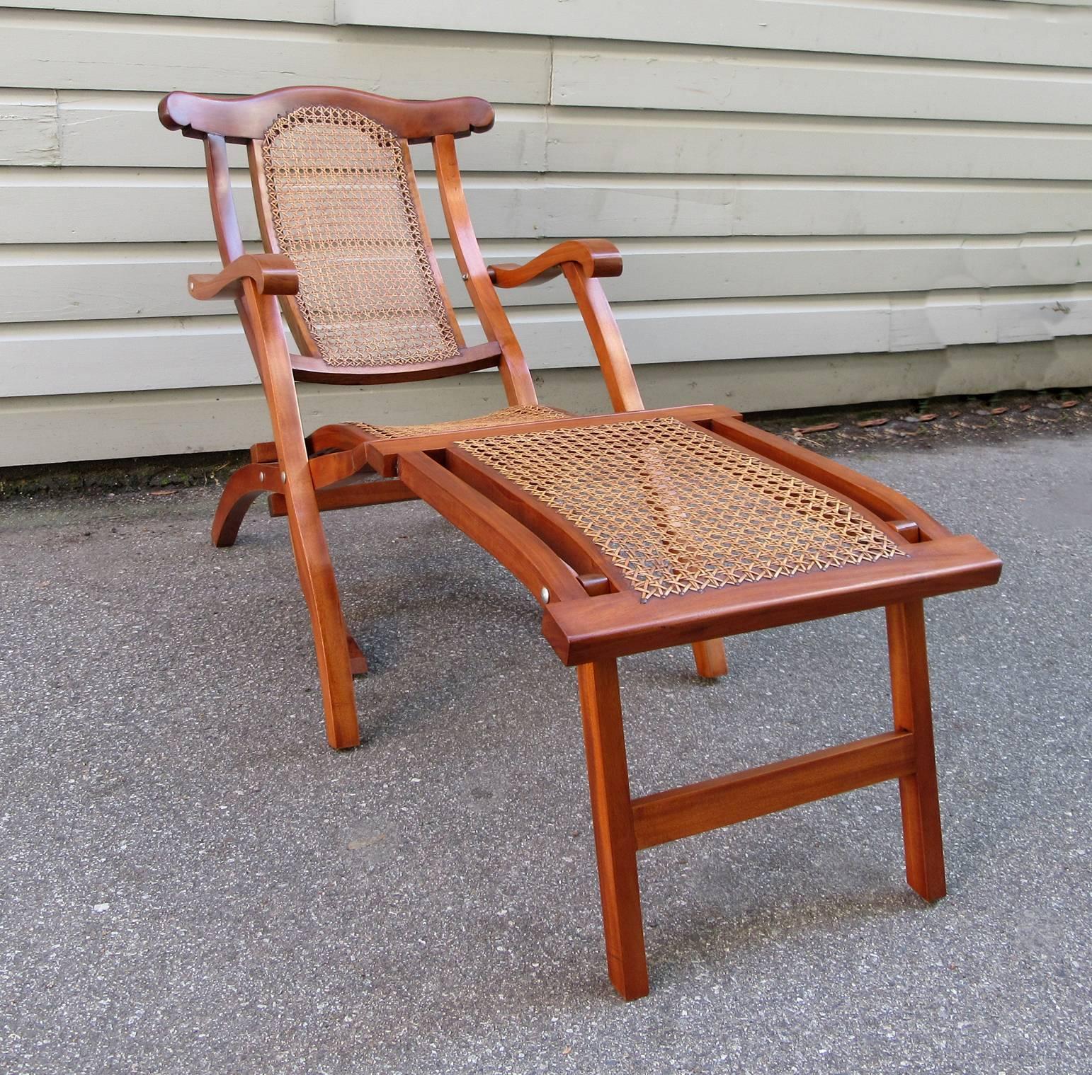 A curvaceous Martinique mahogany folding deck chair, circa 1910, featuring original, hand-tied caning and in excellent condition.