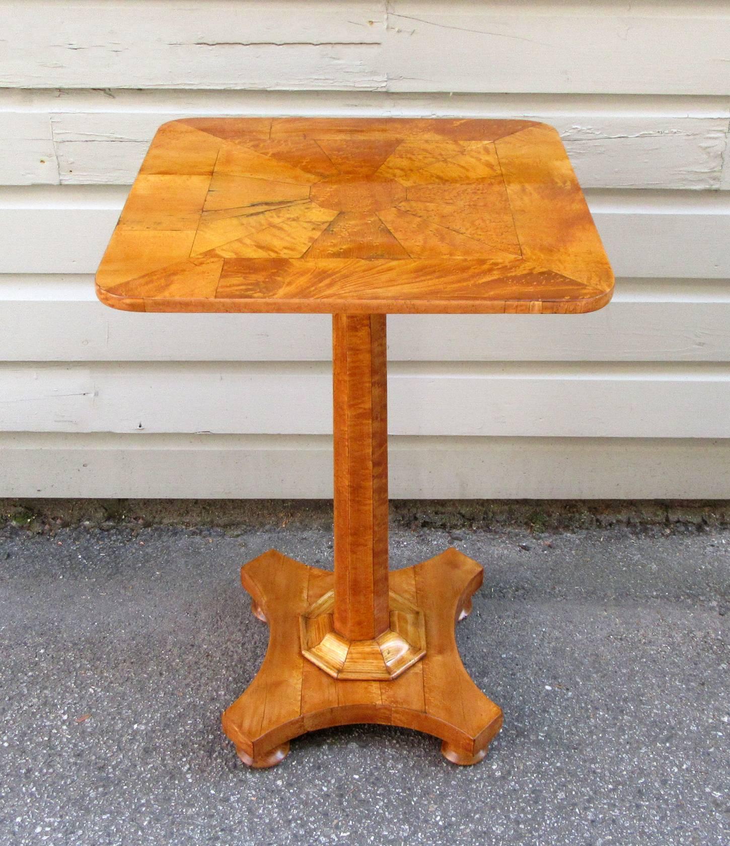 A very fine 19th century English Regency pedestal table, circa 1820, featuring a lustrous bird's-eye maple top and column pedestal base with trumpet collar and feet made from ash.