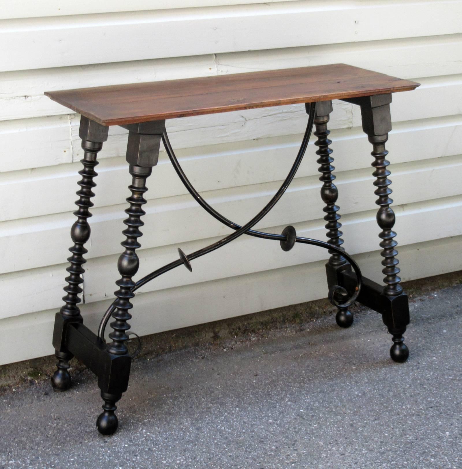 A late 19th century Italian Baroque walnut bobbin turned trestle table, circa 1880, with graceful iron stretcher and nicely turned legs.