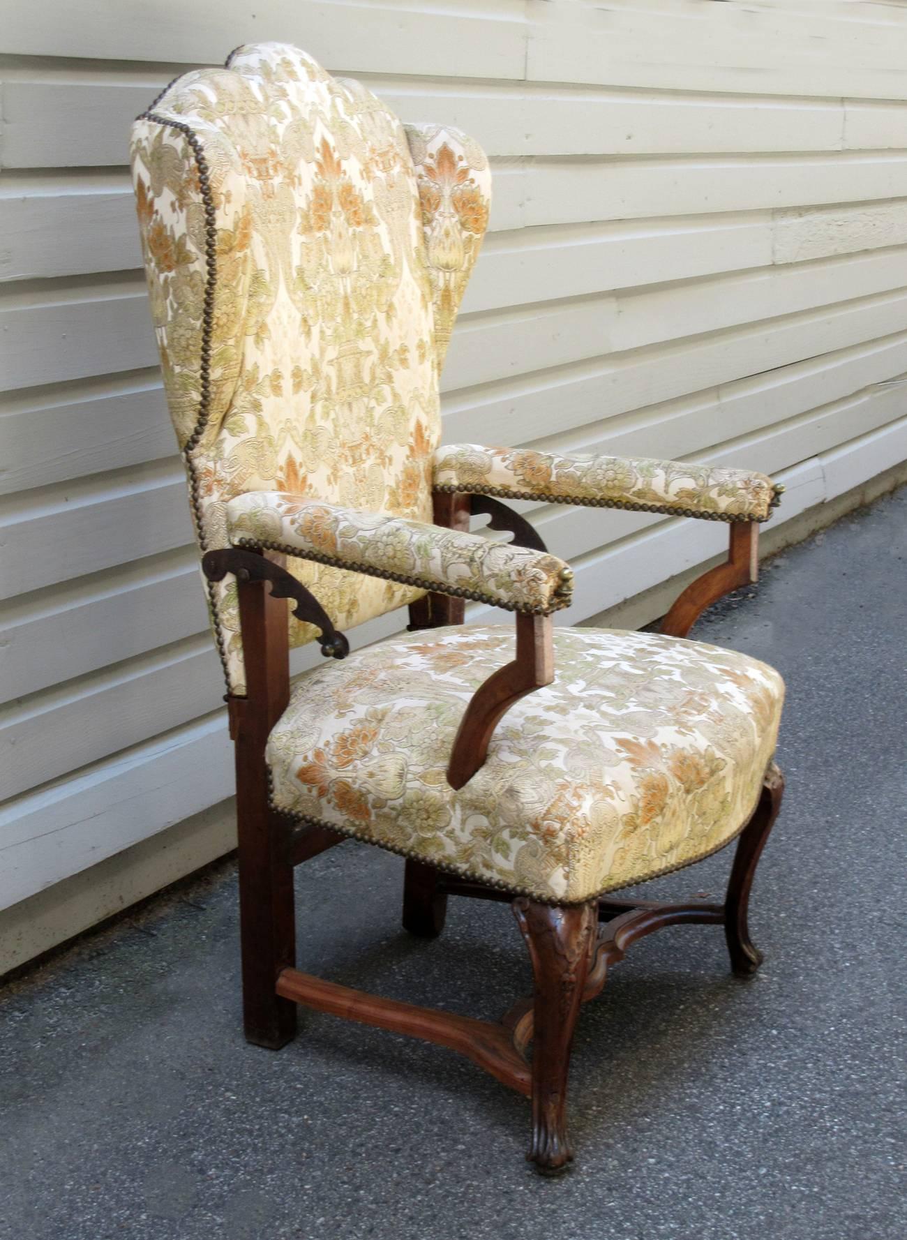 A late 18th century French Provincial reclining upholstered wingback chair, circa 1760, with steel extenders and William & Morris style upholstery in overall good condition.