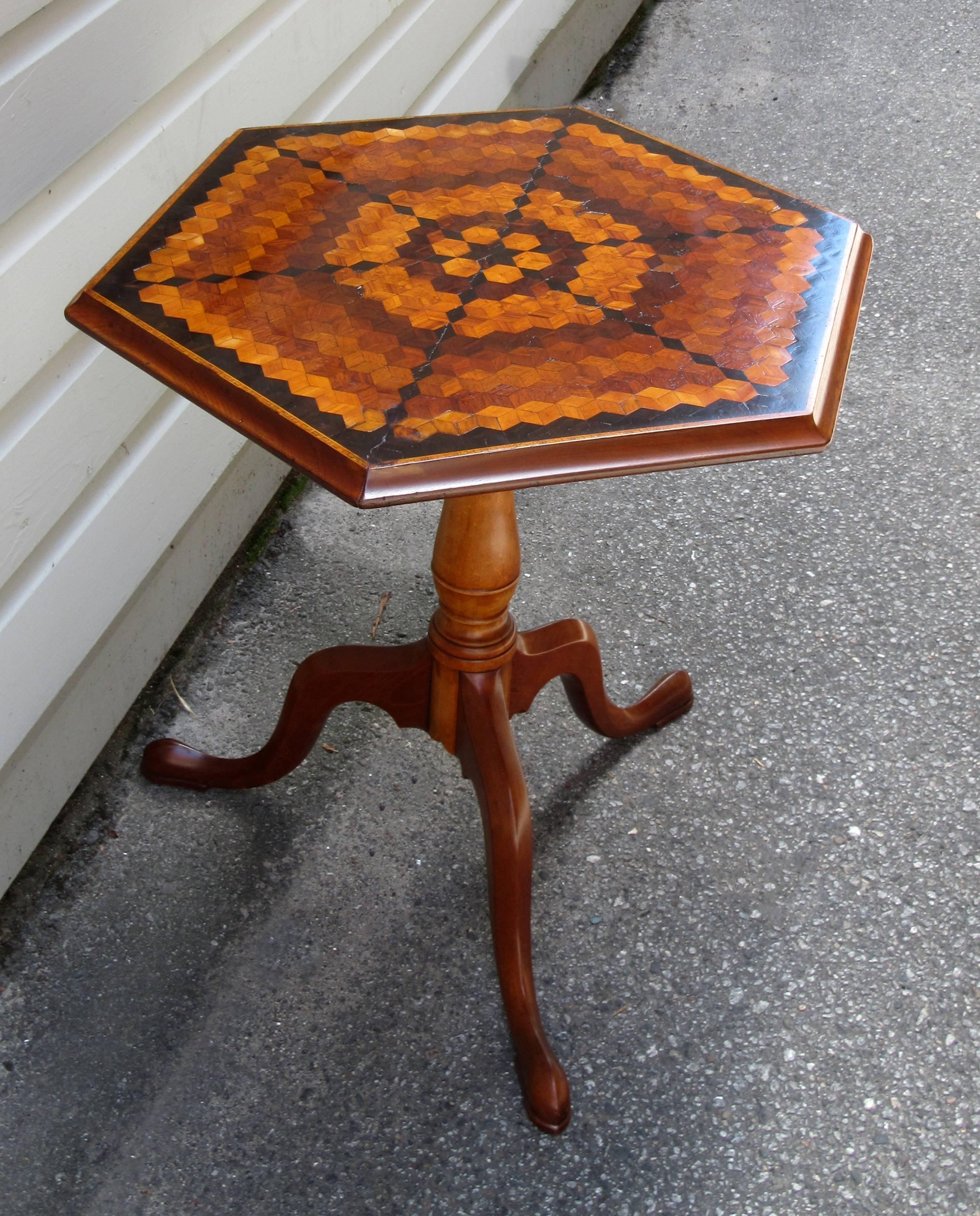A late 18th century English neoclassical maple tilt-top table, circa 1780, with hexagonal specimen top on tripod cabriole pedestal base with each leg ending in a pad foot.