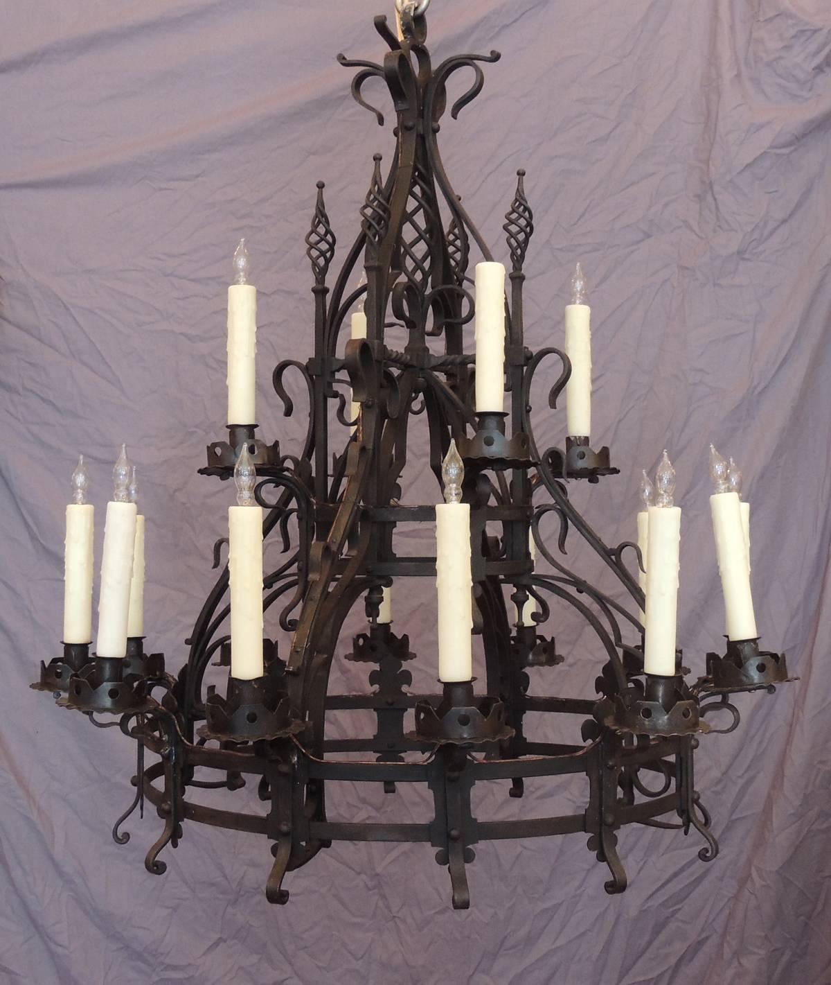 This chandelier was made in France in the mid-19th century, circa 1860. This hand-wrought iron chandelier was made in the French Gothic taste with four top spiral finials placed on a center hollow structure. This twenty-two light fixture was