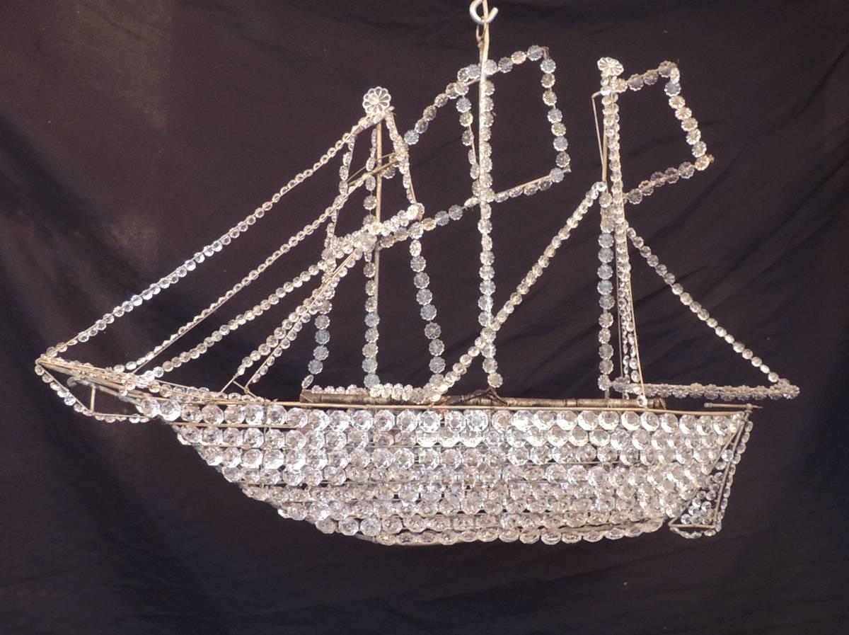 This chandelier was made in France in the late-19th century, circa 1890, and was created in the shape of a Barque sailing vessel. The body, masts, and hull, are made of tole and iron that is covered with crystal beading. This chandelier also has a