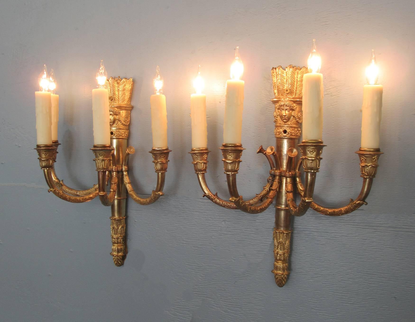 These mid-19th century French bronze sconces, circa 1840, are shaped like quivers and have four candle arms shaped like hunting horns. Originally gas, they have been cleaned and rewired with new porcelain sockets. 