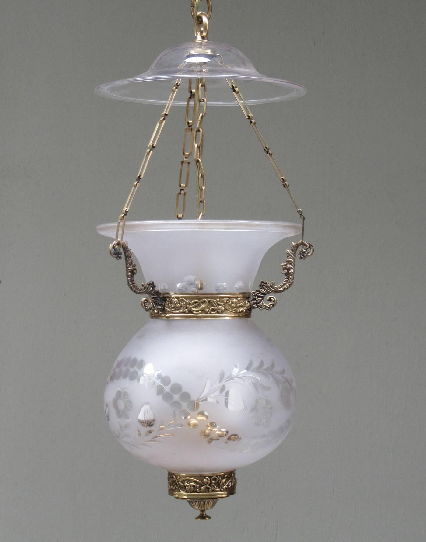 An early 19th century English Regency frosted glass bell jar lantern with brass, circa 1830, featuring floral etchings, three pendant drop and smoke bell. The bell jar alone measures 14